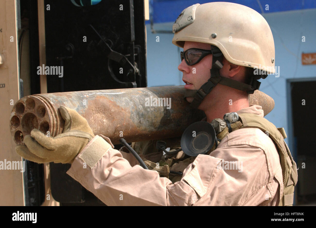 061030-F-7426P-311 Ad Diwaniyah, Iraq (Oct. 30, 2006) - U.S. Navy Explosive Ordnance Technician 1st Class Donnie Walkey, assigned to Explosive Ordnance Disposal Mobile Unit Three (EODMU-3), carries a 107 mm rocket out of the Iraqi police headquarters in Ad Diwaniyah, Iraq, for transport to Camp Echo. EODMU-3 responded to the Iraqi police headquarters to recover a cache of explosives found by policemen during a checkpoint vehicle search. U.S. Air Force photo by Tech. Sgt. Dawn M. Price  (RELEASED) US Navy 061030-F-7426P-311 U.S. Navy Explosive Ordnance Technician 1st Class Donnie Walkey, assign Stock Photo