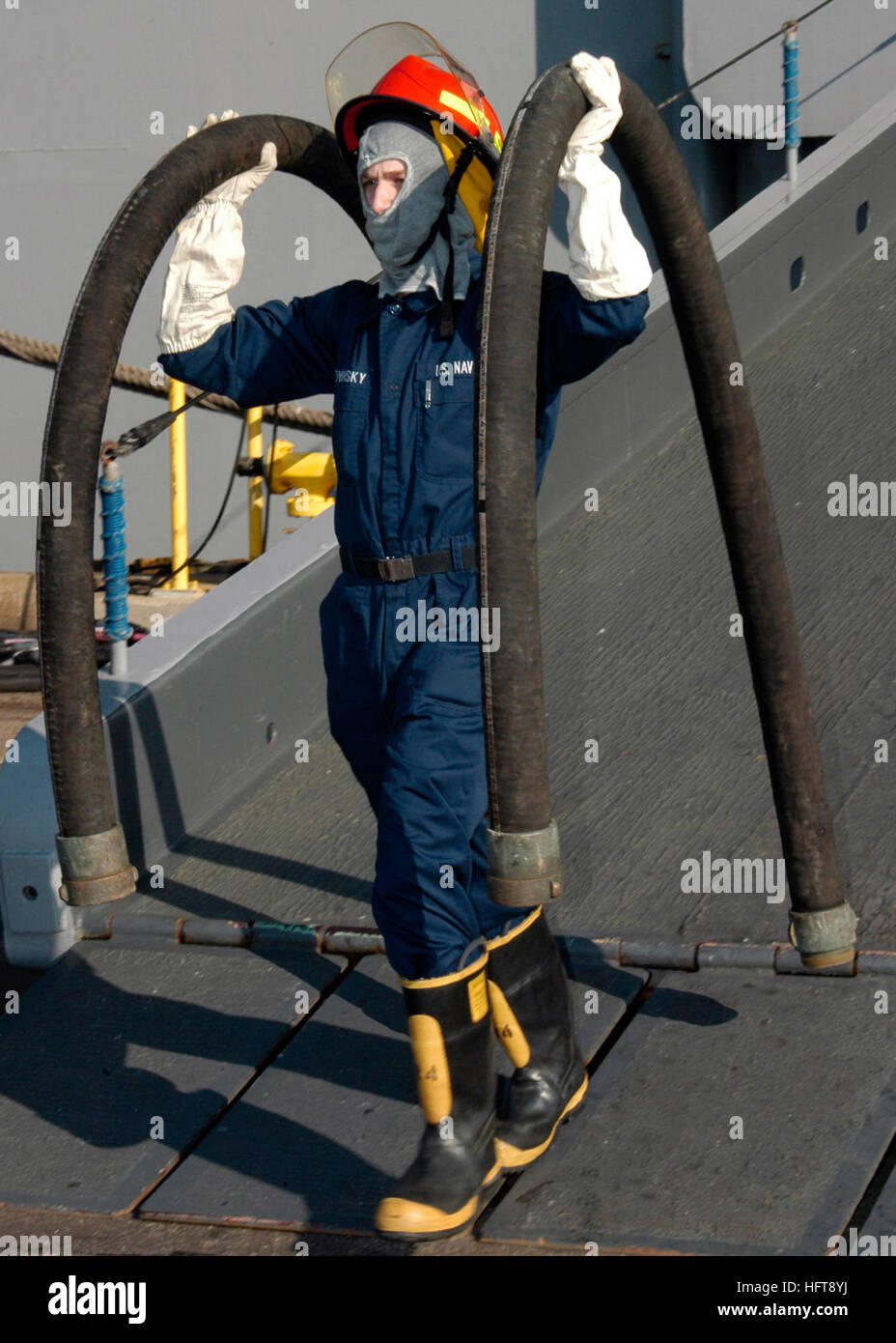 061101-N-7292N-005 Norfolk, Va. (Nov. 1, 2006) - Damage Controlman Fireman John Bukovinsky carries two non-collapsible hard rubber suction hoses during damage control competition events held onboard the amphibious assault ship USS Kearsarge (LHD 3) in support of Surface Line Week. U.S. Navy photo by Mass Communication Specialist 3rd Class Christen R. Nicholas (RELEASED) US Navy 061101-N-7292N-005 Damage Controlman Fireman John Bukovinsky carries two non-collapsible hard rubber suction hoses during damage control competition Stock Photo