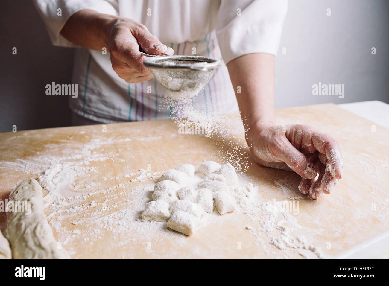 Two hands making dough for meat dumplings. Stock Photo