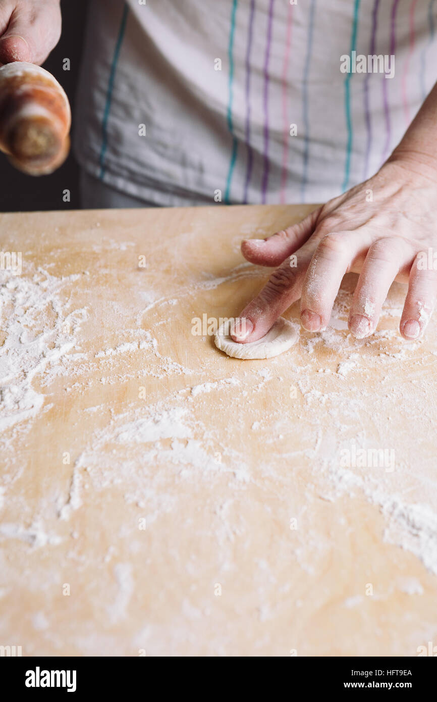 Two hands making dough for meat dumplings. Stock Photo