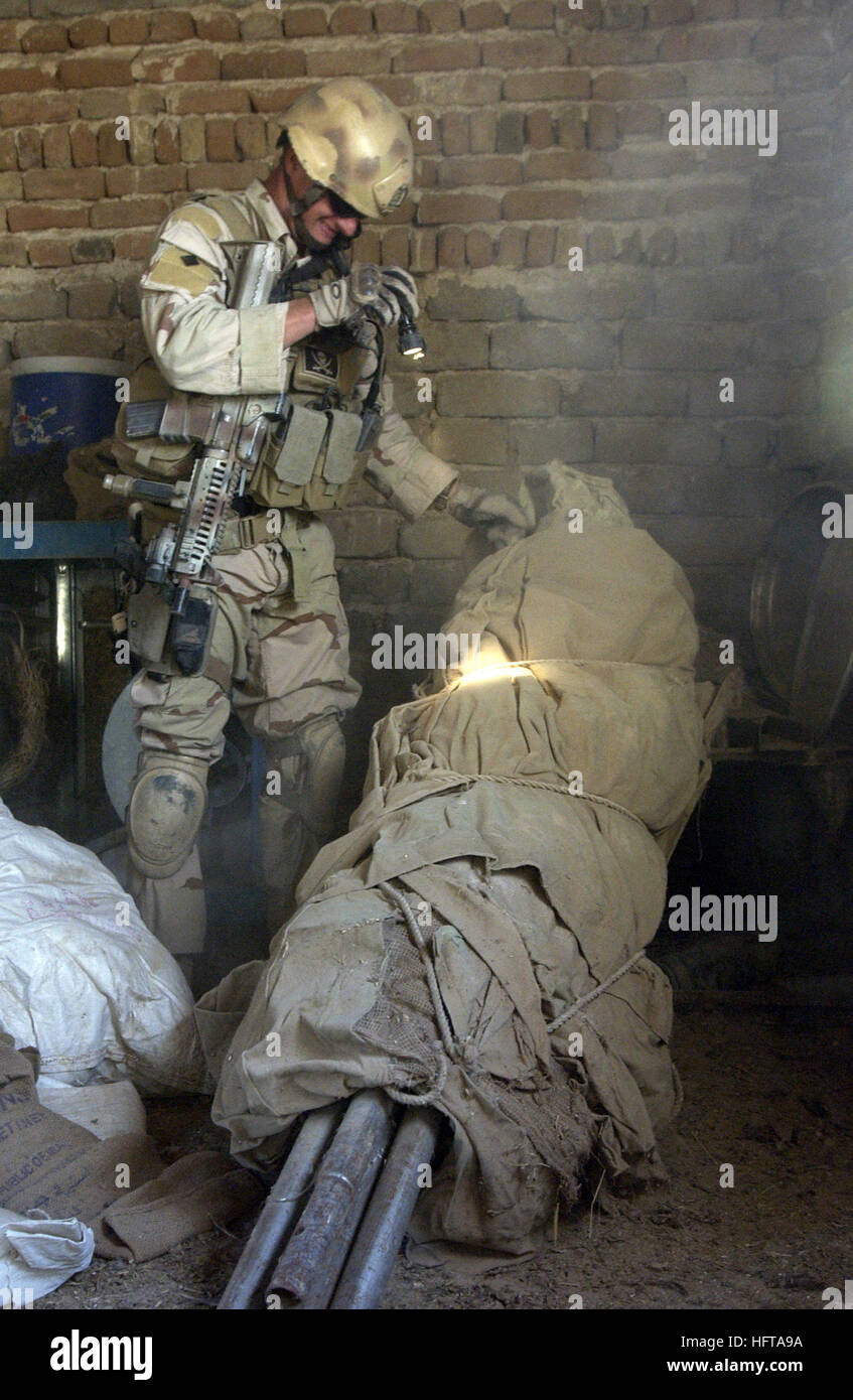 061120-F-7426P-297 Camp Echo Ad Diwaniyah, Iraq (Nov. 20, 2006) - U.S. Navy Explosive Ordnance Disposal (EOD) Technician 1st Class Travis J. Schellpeper attached to the Explosive Ordnance Disposal Mobile Unit Three (EODMU-3), Multi-National Division Central South, Camp Echo, Iraq, systematically searches outside a residence for any evidence of a weapons cache during a cordon and search at the home of a suspected insurgent in the village of Al Naimi, Iraq. EODMU-3 along with Polish and Iraqi army soldiers responded to the home based on information obtained from an informant. U.S. Air Force phot Stock Photo