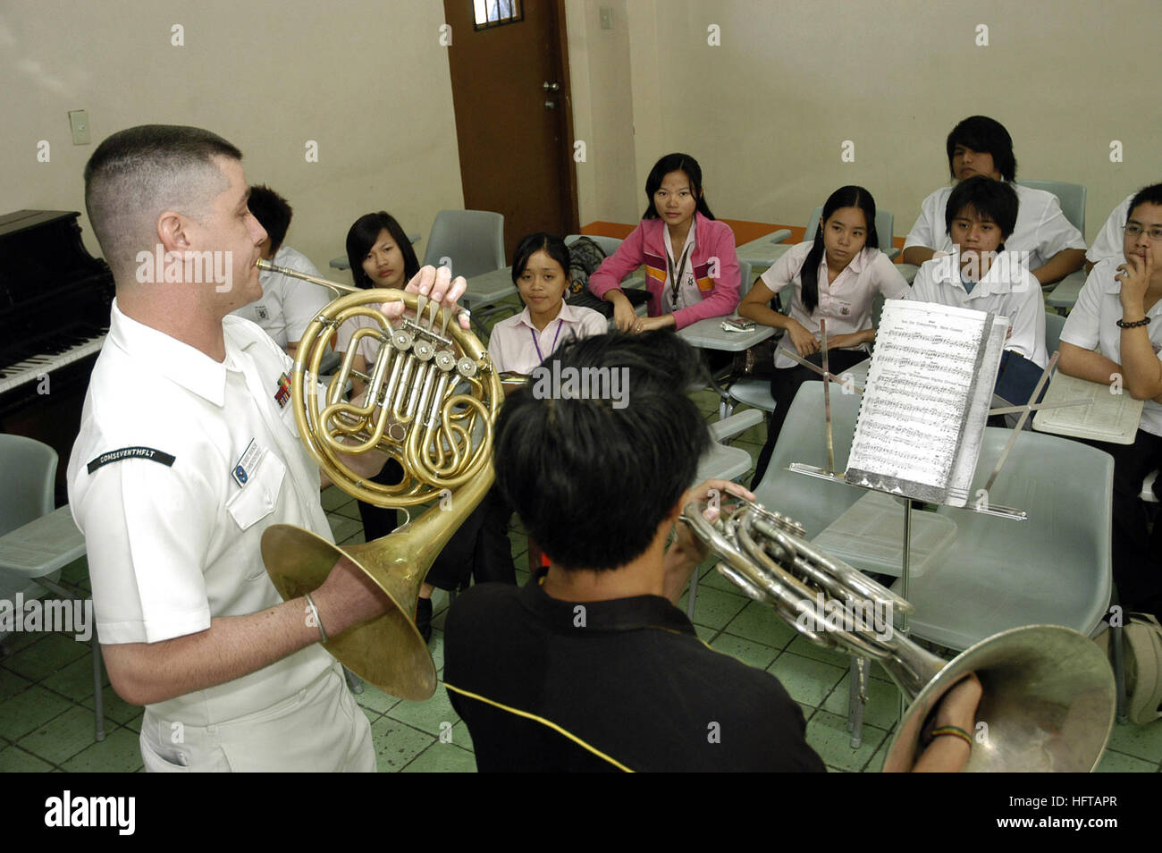 070209-N-2746N-111 Manila, Philippines (Feb. 9, 2007) - Musician 2nd Class Robert Booker, assigned to the 7th Fleet Band, instructs Karlo Espirito of the University of Santo Tomas Conservatory of Music and fellow students on the ins-and-outs of the French horn during a master class held at the university. Amphibious command ship USS Blue Ridge (LCC 19) and embarked 7th Fleet staff are in the Philippines as part of Project Friendship, a humanitarian assistance/community service project with the Armed Forces of the Philippines. Throughout their stay, the ship will participate in friendship-build Stock Photo
