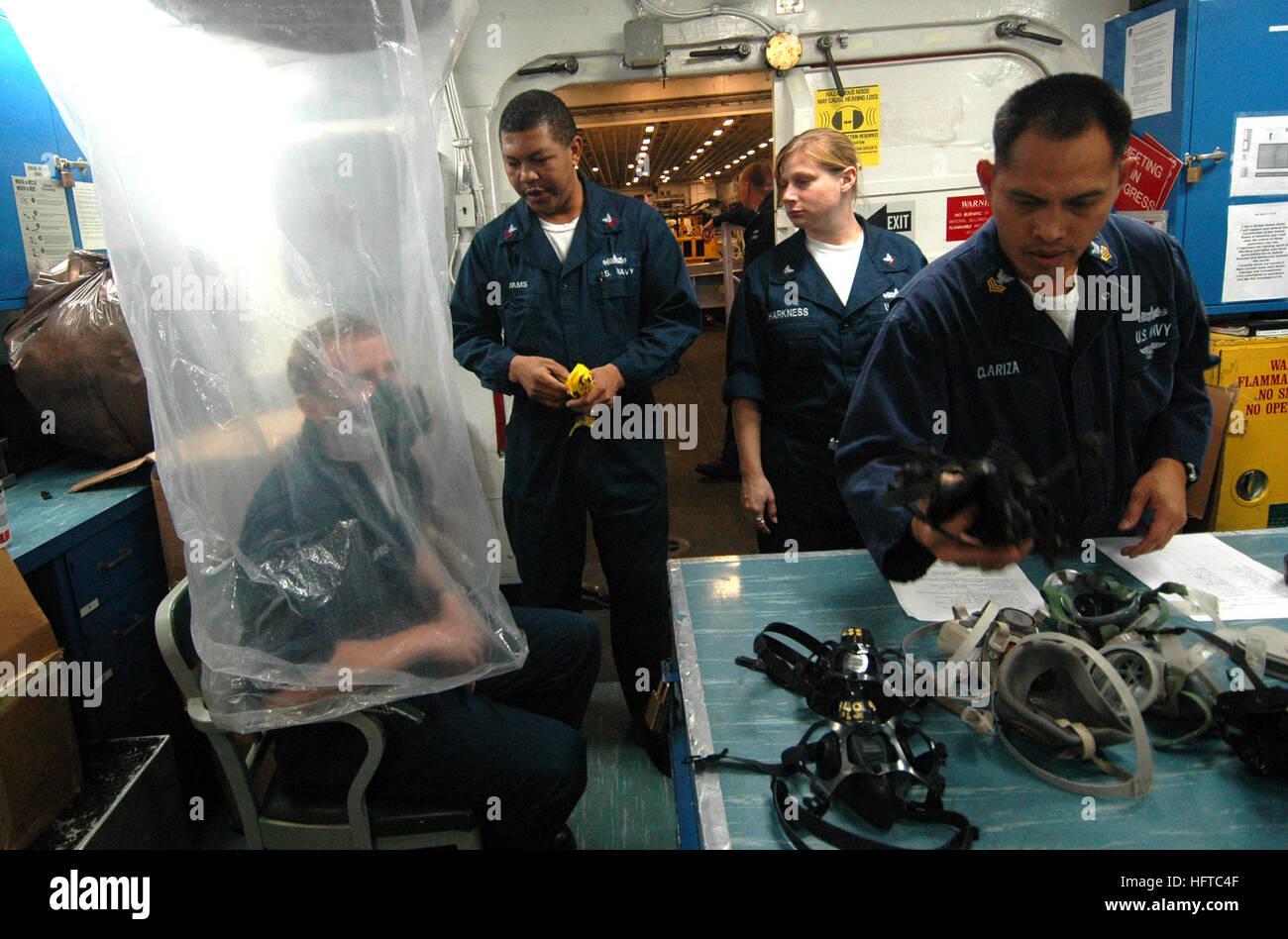 Sailors aboard USS Boxer (LHD 4) conduct respirator fit testing using a ...