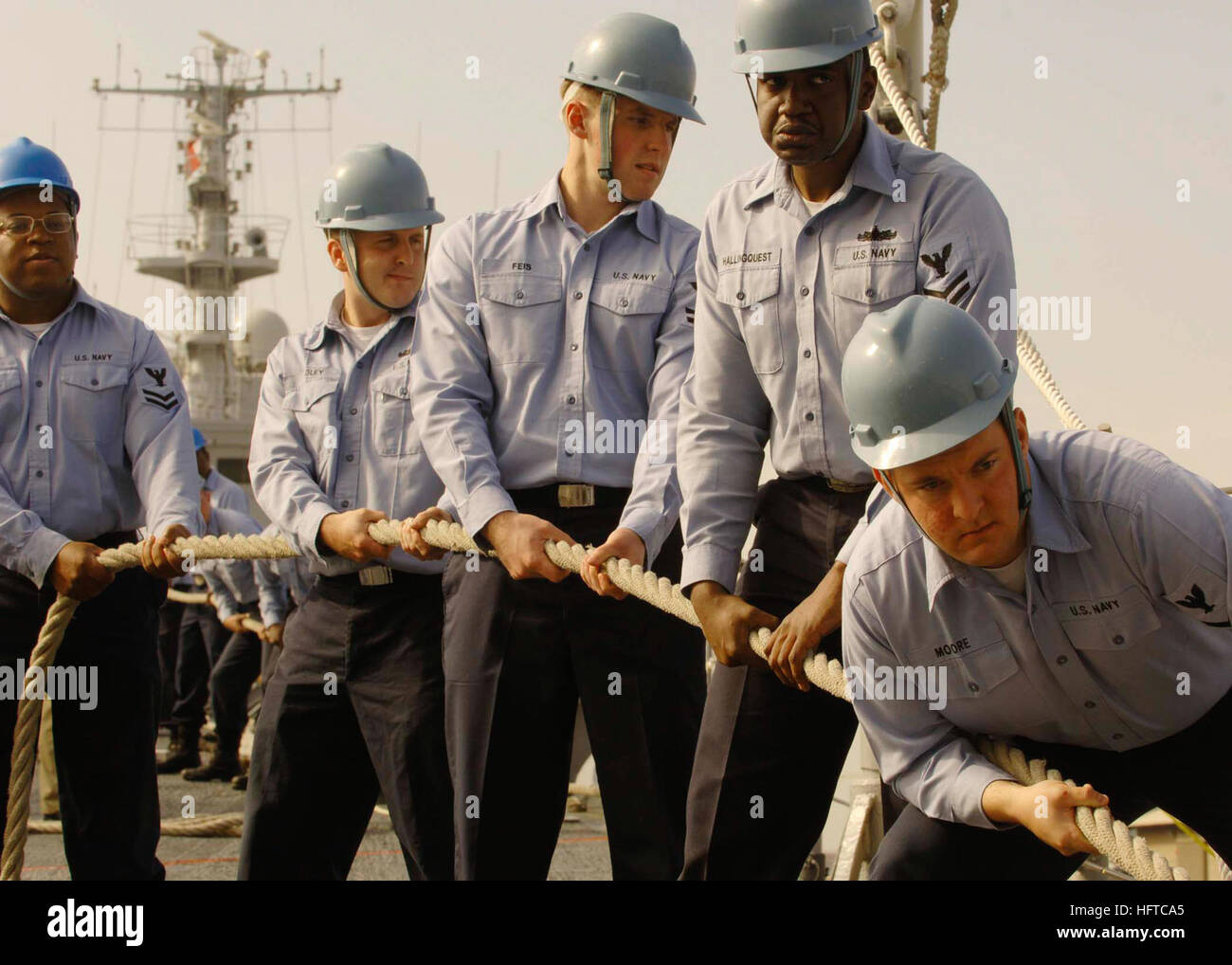 Line handlers aboard guided-missile cruiser USS Anzio (CG 68) prepare ...