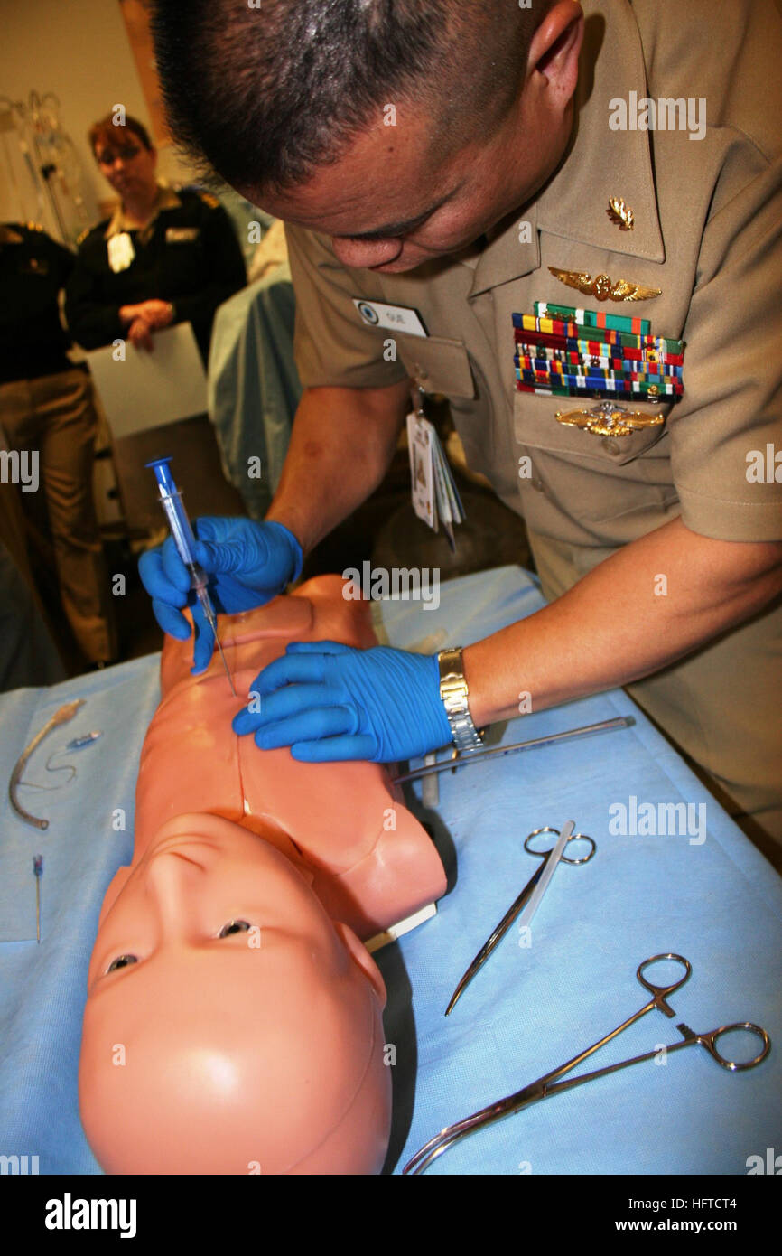 101118-N-8191S-002 BREMERTON, Wash. (Nov. 18, 2010) Lt. Cmdr. Kevin Gue, a critical care nurse for the Intensive Care Unit at Naval Hospital Bremerton, practices rendering emergency aid to a pediatric casualty during the grand opening of the Naval Hospital Bremerton Simulation Center. The center will allow Navy doctors, nurses, hospital corpsmen and support staff to prepare for a wide range of medical emergencies. (U.S. Navy photo by Douglas H. Stutz/Released) US Navy 101118-N-8191S-002 Lt. Cmdr. Kevin Gue, a critical care nurse for the Intensive Care Unit at Naval Hospital Bremerton, Stock Photo