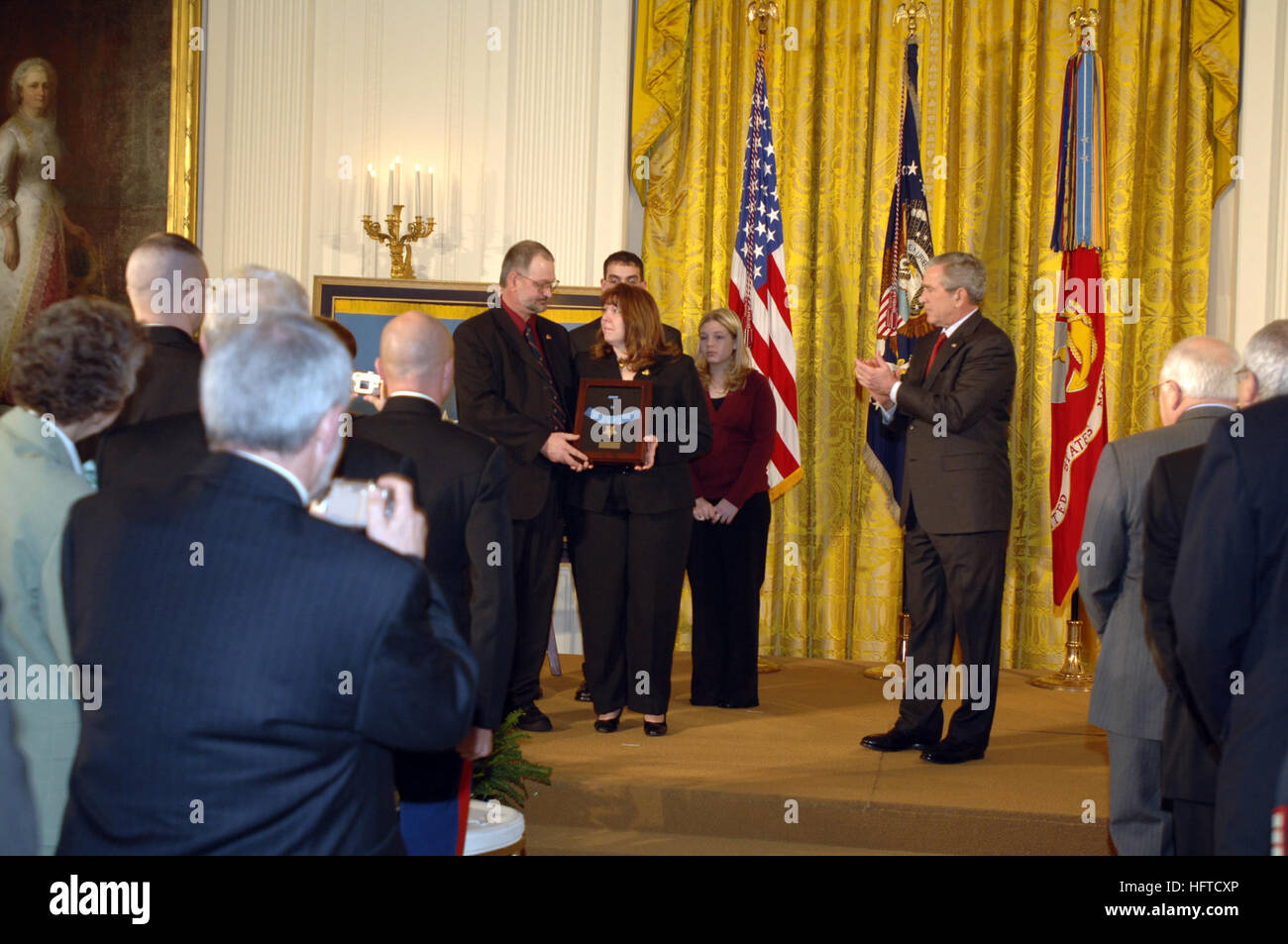 070111-N-1993R-027 Washington, D.C. (Jan. 11, 2007) Ð President George W. Bush stands aside after presenting the Medal of Honor to the family of Cpl. Jason L. Dunham during a ceremony at the White House. Dunham died April 22, 2004, at Bethesda Naval Hospital in Bethesda, Md., of injuries sustained on April 14, when he used his body to shield fellow Marines from a grenade explosion in Husaybah, Iraq. U.S. Navy photo by Mass Communication Specialist 1st Class Rob Rubio (RELEASED) US Navy 070111-N-1993R-027 President George W. Bush stands aside after presenting the Medal of Honor to the family of Stock Photo
