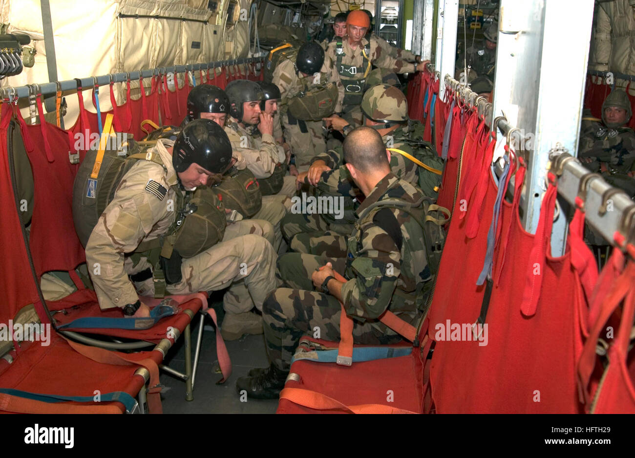 070308-N-3884F-040 CAMP LEMONIER, Djibouti (March 8, 2007) - Members from  the French Foreign Legion and U.S. services stationed at Camp Lemonier  prepare to jump from a plane while training on equipment familiarization