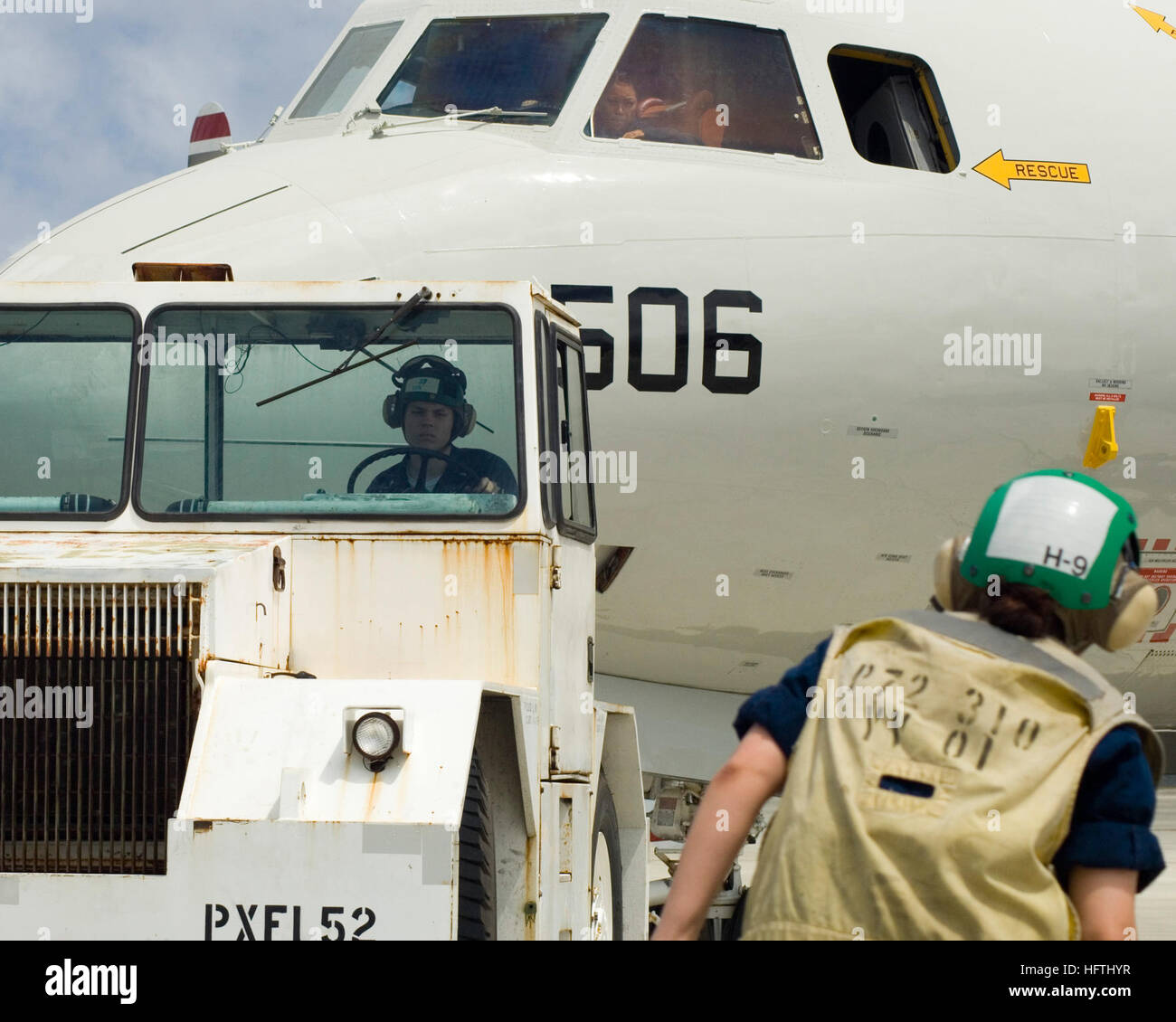 070319-N-3398B-143  KANEOHE BAY, Hawaii (March 19, 2007) - Airplane director, Aviation Electricians Mate 2nd Class Leanne H. McCollum of Patrol Squadron (VP) 47, directs Aviation Structural Mechanic 3rd Class Brandon A. Haag as they tow the P-3C Orion during a competitive exercise know as the Flight Line Rodeo. Four competing teams from VP-47's maintenance department competed in five events during the Flight Line Rodeo for a custom designed belt buckle and bragging rights. U.S. Navy photo by Mass Communication Specialist 3rd Class Kevin S. Beauchamp (RELEASED) US Navy 070319-N-3398B-143 Airpla Stock Photo