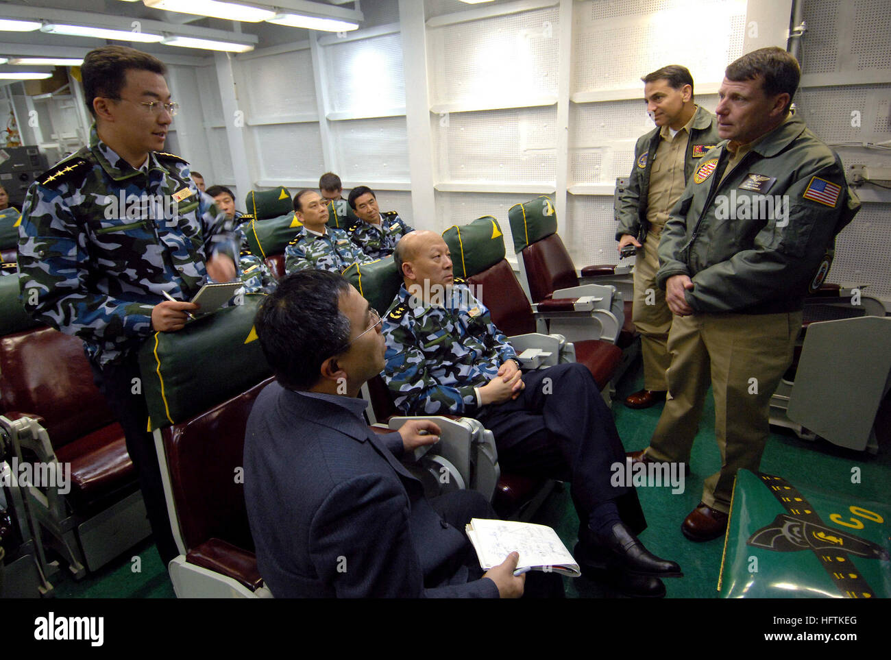 070406-N-5345W-339  ATLANTIC OCEAN (April 6, 2007) - Commander, Carrier Strike Group (CSG) 10 Rear Adm. William Gortney fields a question from Chinese People's Liberation Army Navy (PLAN) Lt. Sun Jian after a carrier-based aviation briefing in Strike Fighter Squadron (VFA) 105's ready room aboard the Nimitz-class aircraft carrier USS Harry S. Truman (CVN 75). Truman is underway conducting Tailored Ship's Training Availability (TSTA). TSTA is a standard used to evaluate a ship's readiness for deployment. U.S. Navy photo by Mass Communication Specialist 3rd Class Kristopher Wilson (RELEASED) US  Stock Photo