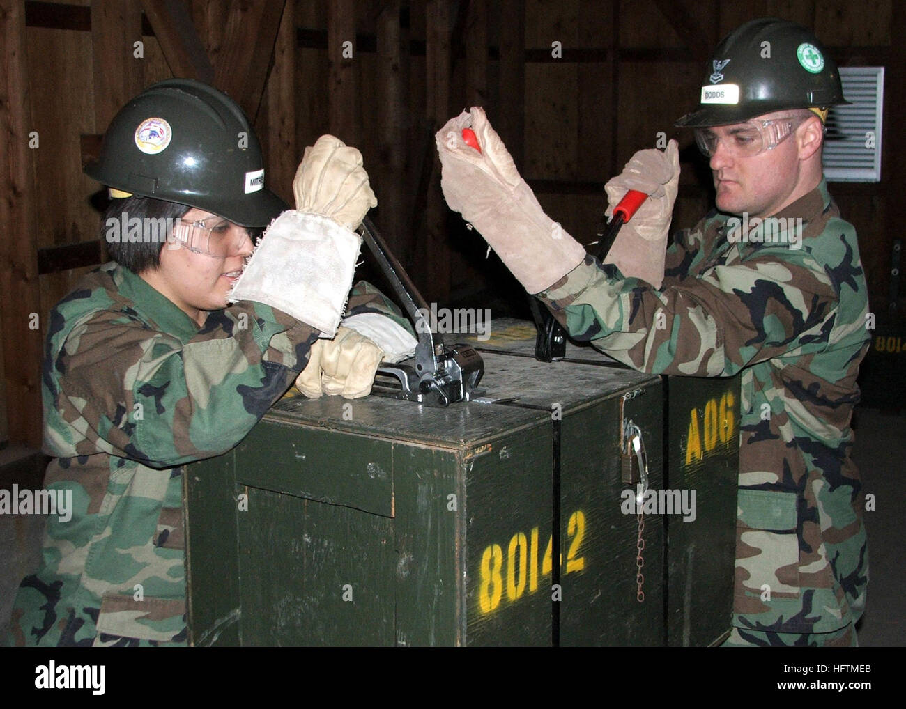 071222-N-8547M-008 IWAKUNI, Japan (Dec. 22, 2007) Builder Constructionman Loren Mitre and Builder 2nd Class Thad Dodds, both of Naval Mobile Construction Battalion (NMCB) 5, Detail Iwakuni, band crates and load them into a conex box for shipment back to Port Hueneme, Calif., during the close out of the Detail Iwakuni site. NMCB-5 is deployed to 11 locations to provide construction support in the Pacific Command’s area of responsibility. U.S. Navy photo by Mass Communication Specialist 3rd Class Patrick W. Mullen III (Released) US Navy 071222-N-8547M-008 Builder Constructionman Loren Mitre and  Stock Photo
