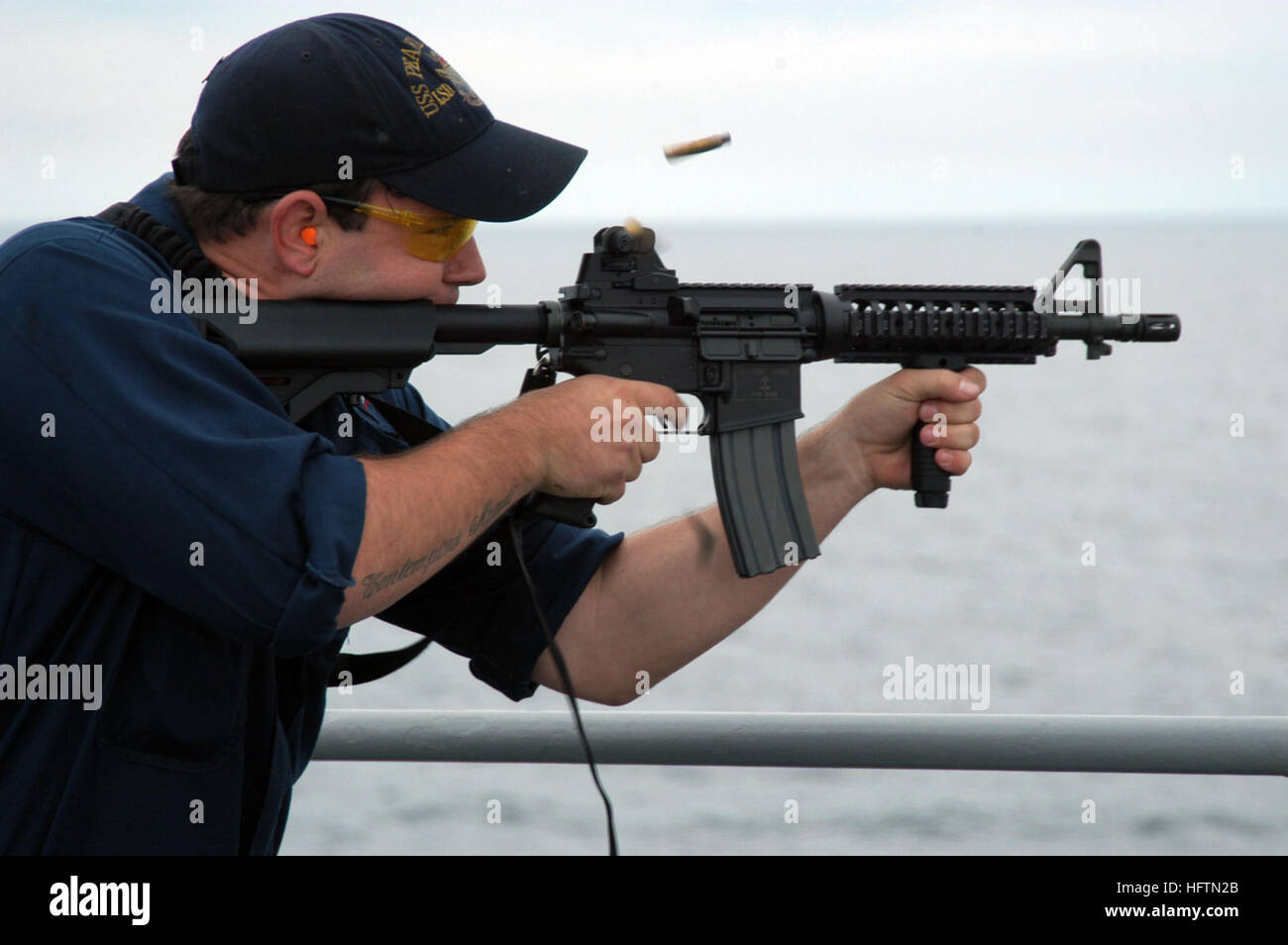 070501-N-7029R-035 ATLANTIC OCEAN (May 1, 2007) - GunnerÕs Mate 3rd Class Louie Mitts shoots an M-16 during a weapons exercise on board USS Pearl Harbor (LSD 52). Pearl Harbor is currently underway in support of Partnership of the Americas (POA) 2007. POA 2007 will focus on enhancing relationships with regional partner nations through a variety of exercises and events at sea and on shore throughout South America and the Caribbean. U.S. Navy photo by Mass Communication Specialist 2nd Class Alexia M. Riveracorrea (RELEASED) US Navy 070501-N-7029R-035 Gunner%%5Ersquo,s Mate 3rd Class Louie Mitts  Stock Photo