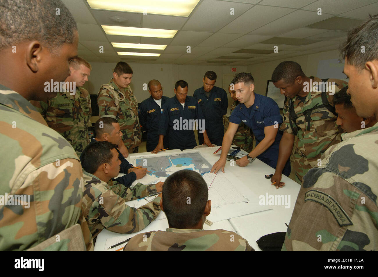 Colon, Panama (07 May 2007), Boatswain's Mate 2nd Class Juan Rodriguez, Expeditionary Training Command, assists Servicio Maritimo Nacional de Panama (Panamanian National Maritime Service) members with finding a point on a map given the latitude and longitude during training on board High Speed Vessel (HSV) 2 SWIFT. Commander, Task Group 40.9 (CTG 40.9) and HSV-2 SWIFT, are deployed as part of the pilot Global Fleet Station (GFS) to the Caribbean basin and Central America.  Global Fleet Station is designed to validate the GFS concept for the Navy and support U.S. Southern Command objectives for Stock Photo