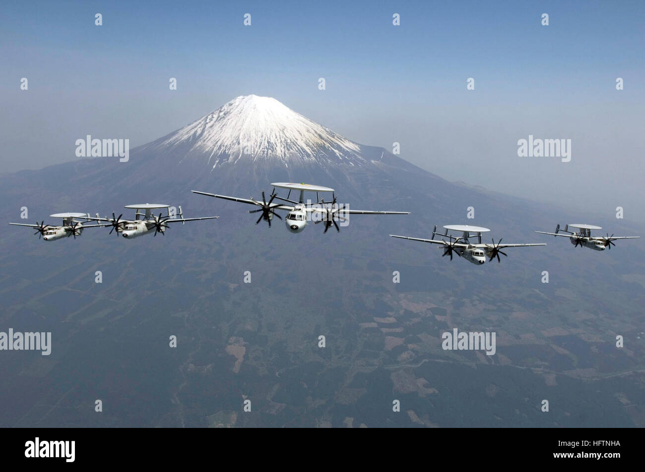 070509-N-8591H-110 MOUNT FUJI, Japan (May 9, 2007) - E-2C Hawkeye's assigned to Carrier Airborne Early Warning Squadron 115 'Liberty Bells,' perform a formation flight in front of Mount Fuji, May 9.  VAW 115 is one of the nine squadrons assigned to the Naval Air Facility Atsugi, Japan-based Carrier Air Wing Five, which is assigned to USS Kitty Hawk (CV 63).  Kitty Hawk operates out of Fleet Activities Yokosuka, Japan. U.S. Navy photo by Mass Communication Specialist 3rd Class Jarod Hodge US Navy 070509-N-8591H-110 E-2C Hawkeyes assigned to the Liberty Bells, of Carrier Airborne Early Warning S Stock Photo