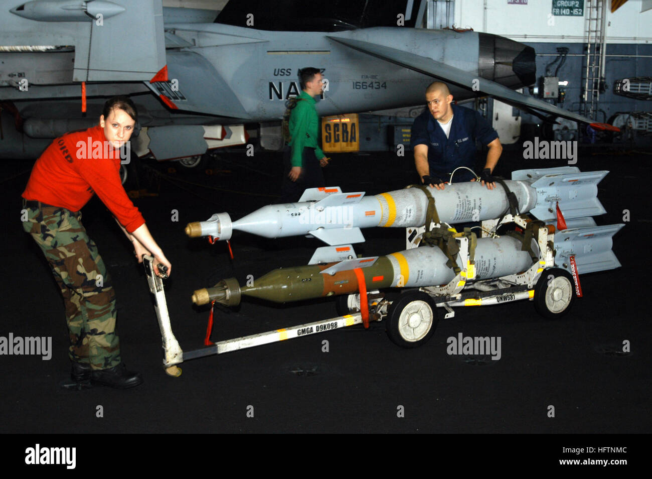 070511-N-1525H-014 INDIAN OCEAN (May 11, 2007) - Aviation Ordnanceman Airman Brittany Hodgson and Aviation Ordnanceman 3rd Class Steve Acosta moves laser guided bombs in the hangar bay aboard the nuclear-powered aircraft carrier USS Nimitz (CVN 68). The Nimitz Carrier Strike Group and embarked Carrier Air Wing (CVW) 11 are deployed in the U.S. 5th Fleet, conducting Maritime Security Operations and supporting troops participating in Operation Enduring Freedom. U.S. Navy photo by Mass Communication Specialist Seaman Matthew Haws (RELEASED) US Navy 070511-N-1525H-014 Aviation Ordnanceman Airman B Stock Photo