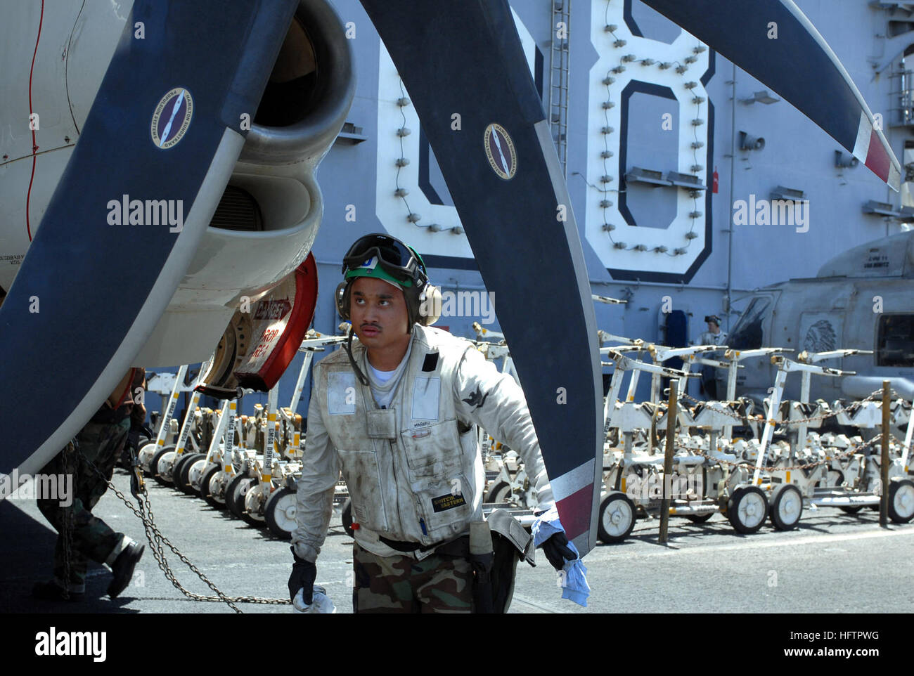 070605-N-3349L-017 PERSIAN GULF (June 5, 2007) - Aviation Machinist's Mate 3rd Class Mikhos Manero, assigned to the 'Wallbangers' of Carrier Airborne Early Warning Squadron (VAW) 117, inspects the propellers on a preflight inspection aboard the nuclear-powered aircraft carrier USS Nimitz (CVN 68). The Nimitz Carrier Strike Group and embarked Carrier Air Wing (CVW) 11 are deployed in the U.S. 5th Fleet conducting maritime operations supporting troops in the global war on terrorism. U.S. Navy photo by Mass Communication specialist 2nd Class Daniel P. Lapierre (RELEASED) US Navy 070605-N-3349L-01 Stock Photo