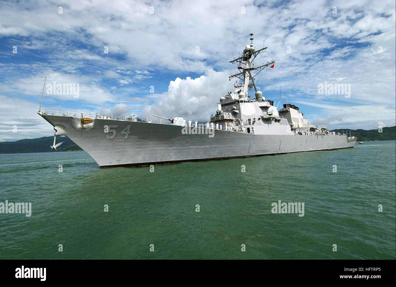 The US Navy (USN) Arleigh Burke Class Guided Missile Destroyer USS CURTIS WILBUR (DDG 54) drops anchor at the Vietnamese port of Da Nang, Vietnam.  The WILBUR arrived for a scheduled port visit, the second USN ship to visit Vietnam and the first to visit Da Nang since 1973. These visits symbolize the continuation of normalized relations between the United States and Vietnam.  The WILBUR is part of the Kitty Hawk Carrier Strike Group (CSG), the Navy's only permanently forward-deployed carrier strike group, currently operating from Yokosuka, Japan. USS Curtis Wilbur (DDG-54) Stock Photo