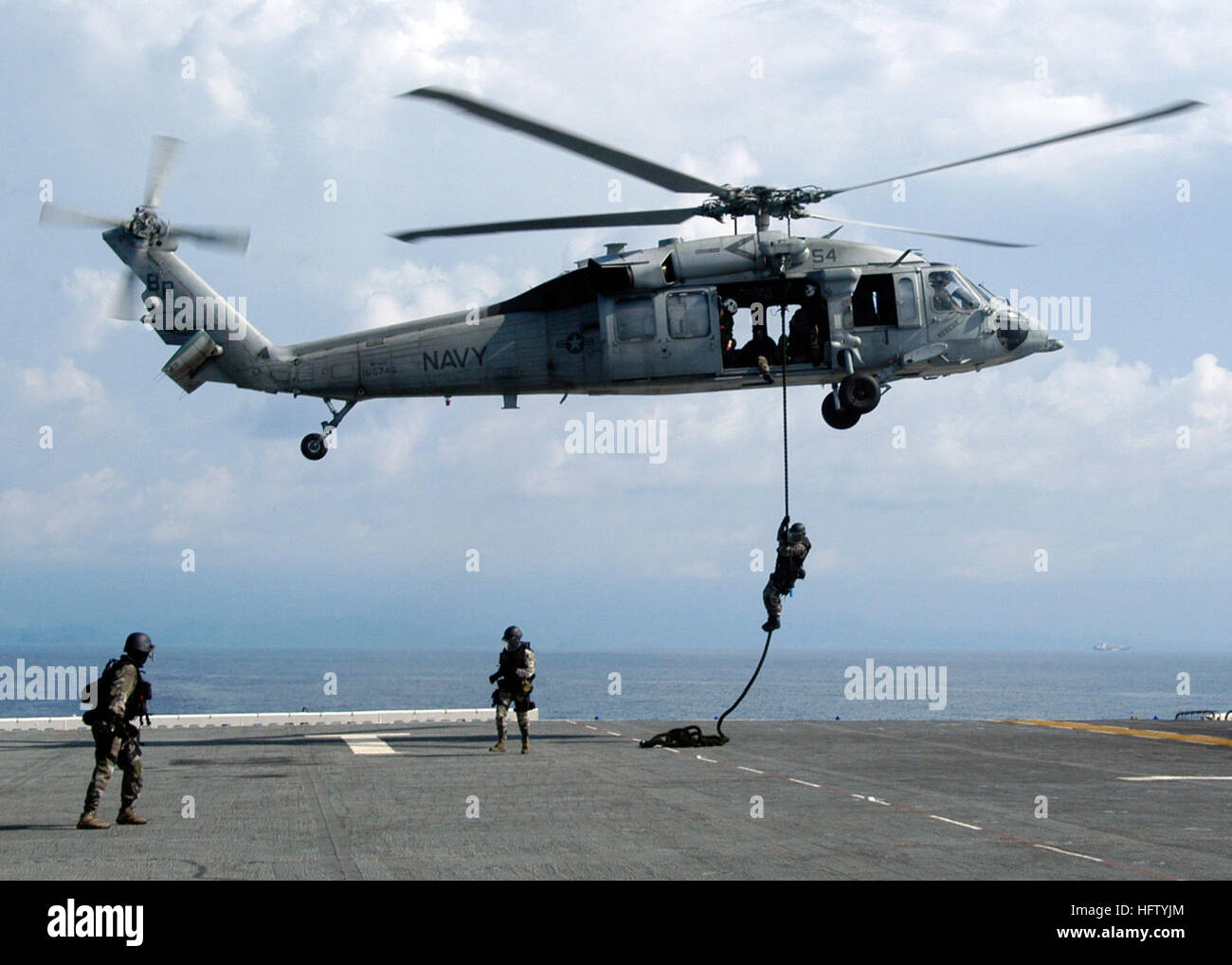 070902-N-3666S-046  CARIBBEAN SEA (Sept. 2, 2007) - French boarding teams rappel out of an U.S. Navy SH-60 Seahawk onto the flight deck of multipurpose amphibious assault ship USS Wasp (LHD 1). Wasp is in Panama as part of the multi-national exercise PANAMAX 2007. Civil and military forces from 19 countries are participating in PANAMAX, a U.S. Southern Command joint and multi-national training exercise co-sponsored with the government of Panama, in the waters off the coast of Panama in Honduras. U.S. Navy photo by Mass Communication Specialist 3rd Class Robbie Stirrup (RELEASED) US Navy 070902 Stock Photo