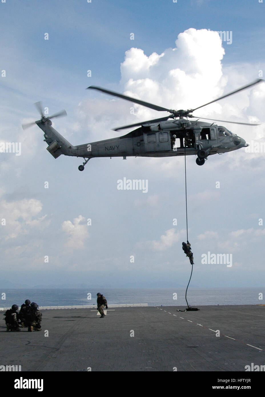 070902-N-3666S-087 Off the Coast of Panama (Sep. 2, 2007) French boarding teams rappel out of a U.S. Navy SH-60 Helicopter onto the flight deck of the Multipurpose Amphibious Assault Ship USS WASP (LHD 1). Wasp is in Panama as part of the multi-national exercise PANAMAX 2007. Civil and military forces from 19 countries are participating in PANAMAX, a U.S. Southern Command joint and multi-national training exercise co-sponsored with the Government of Panama, in the waters off the coast of Panama in Honduras. U.S. Navy photo by Mass Communication Specialist 3rd Class Robbie Stirrup (RELEASED) US Stock Photo