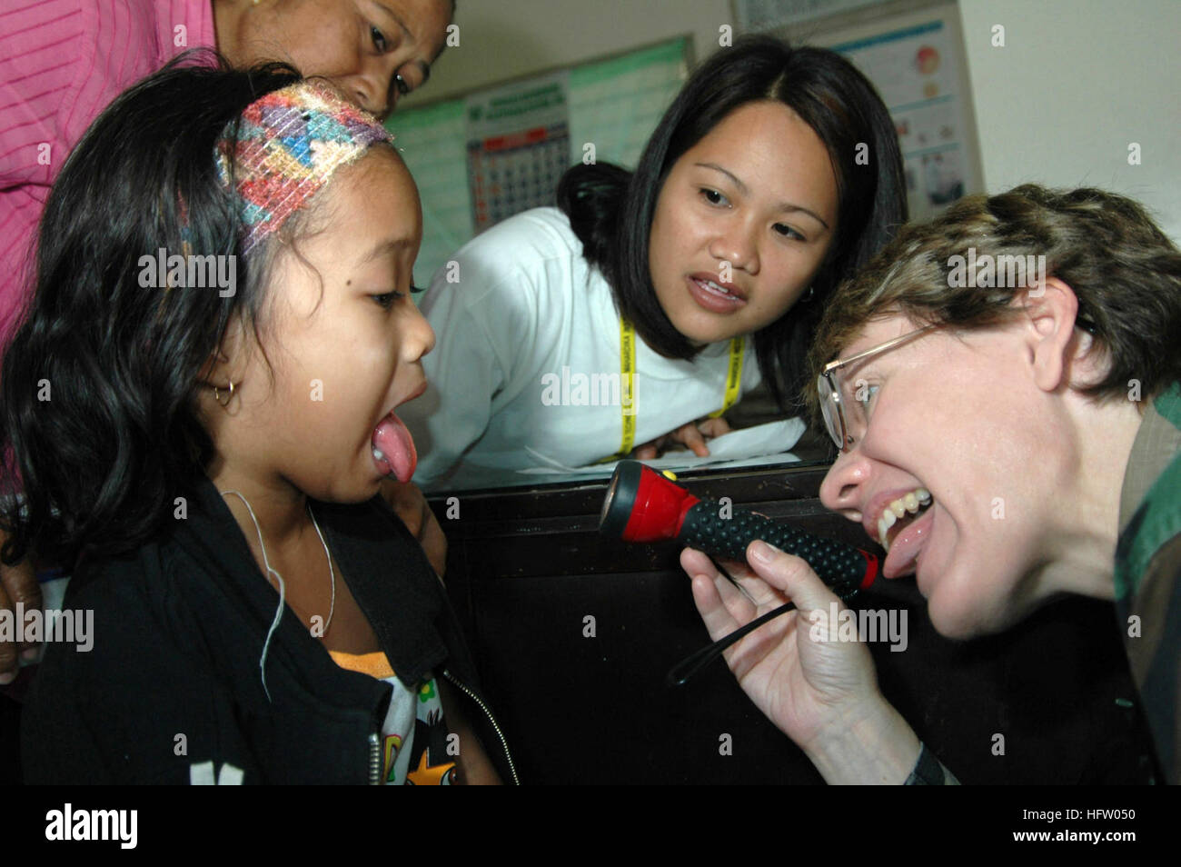 060613-N-3532C-033 Tawi Tawi, Philippines (June 13, 2006) Ð Air Force Maj. Valerie Clegg, a pediatrician with the Medical Treatment Facility aboard the U.S. Military Sealift Command (MSC) Hospital Ship USNS Mercy (T-AH 19), examines a young girl at Datu Halun Sakilan Memorial Hospital during the shipÕs visit to the city on a scheduled humanitarian mission. As part of its five-month humanitarian assistance deployment to South and Southeast Asia, and the Pacific Islands, the crew aboard Mercy will spend several days delivering medical care to local residents. The crew will conduct medical operat Stock Photo