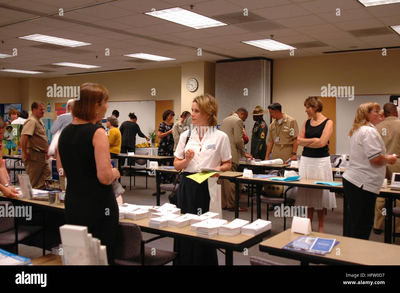 060601-N-6700F-020 Norfolk, Va. (June 1, 2006) - Kathleen Thompson, an information referral specialist for the Hampton Roads Fleet and Family Service Center (FFSC) receives information from one of 28 civilian and military organizations during FFSC's Resource Fair in Norfolk.  The fair is designed to help Sailors and their families find different forms of support available for them; including, American Red Cross, parenting and pre-deployment services. U.S. Navy photo by Lithographer Seaman Apprentice Shanika Futrell (RELEASED) US Navy 060601-N-6700F-020 Kathleen Thompson, an information referra Stock Photo
