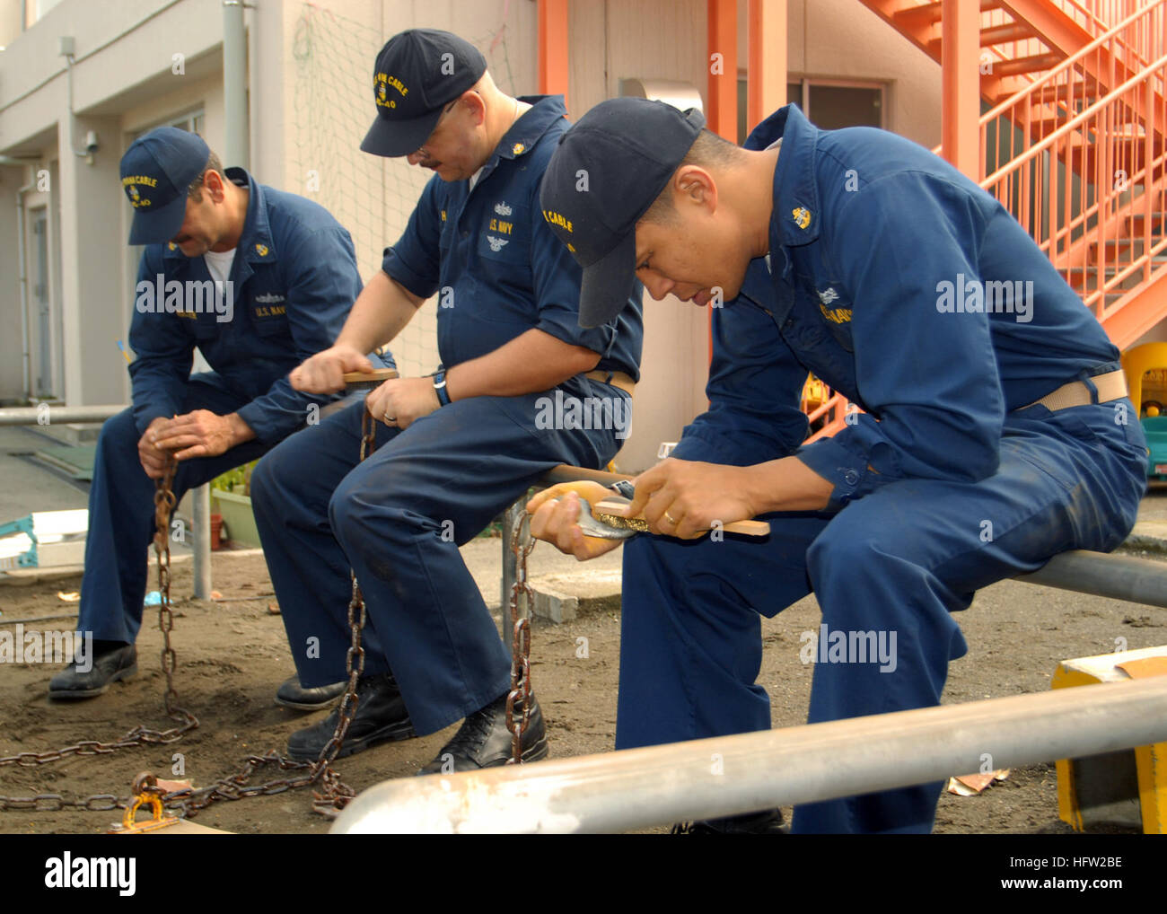 071103-N-5621B-097 YOKOSUKA, Japan (Nov. 3, 2007) Ð Three chief petty officers use wire brushes to clean rust off playground swing chains during a community relations project sponsored by USS Frank Cable (AS 40). The submarine tender is in Yokosuka for a routine port visit. U.S. Navy photo by Mass Communication Specialist 2nd Class Stefanie Broughton (RELEASED) US Navy 071103-N-5621B-097 Three chief petty officers use wire brushes to clean rust off playground swing chains during a community relations project sponsored by USS Frank Cable (AS 40) Stock Photo