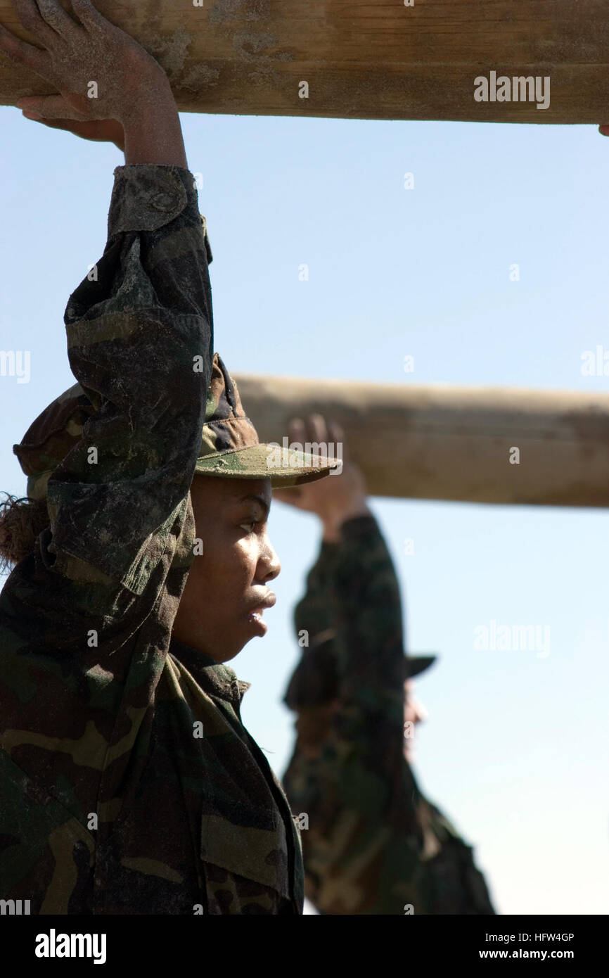 A participant completes a log physical training evolution at the Naval ...