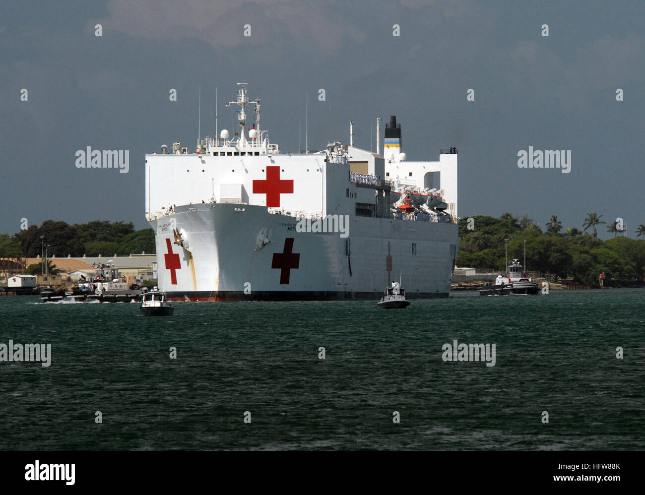 080508-N-4965F-256 PEARL HARBOR, Hawaii (May 8, 2008) Tugboats assigned to Naval Station (NAVSTA) Pearl Harbor assist the Military Sealift Command hospital ship USNS Mercy (T-AH 19) as she maneuvers into Pearl Harbor. Mercy is en route for a humanitarian mission to the western Pacific and Southeast Asia supporting Pacific Partnership 2008. Pacific Partnership 2008 is designed to strengthen the goodwill developed during previous humanitarian civic assistance missions. Mercy is scheduled to visit the Republic of Philippines, Vietnam, Timor Leste, Papua New Guinea and the Federated States of Micr Stock Photo