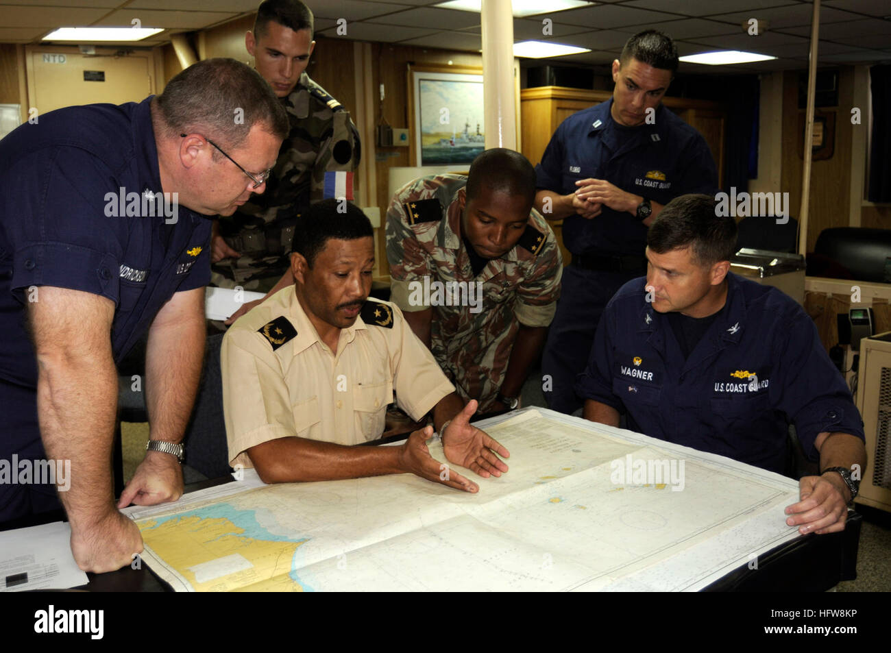 080607-G-2443T-001 MINDELO, Cape Verde (June 7, 2008) Coast Guard Capt. Robert Wagner, right, commanding officer of the Coast Guard Cutter USCG Dallas (WHEC 716), and law-enforcement officers discuss tactics during an operational brief aboard the ship. Dallas is deployed under the direction of Commander, U.S. Naval Forces Europe, 6h Fleet supporting Africa Partnership Station (APS), an initiative aimed at strengthening global-maritime partnerships through training and other collaborative activities in order to improve global maritime safety and security. U.S. Coast Guard photo by Petty Officer Stock Photo