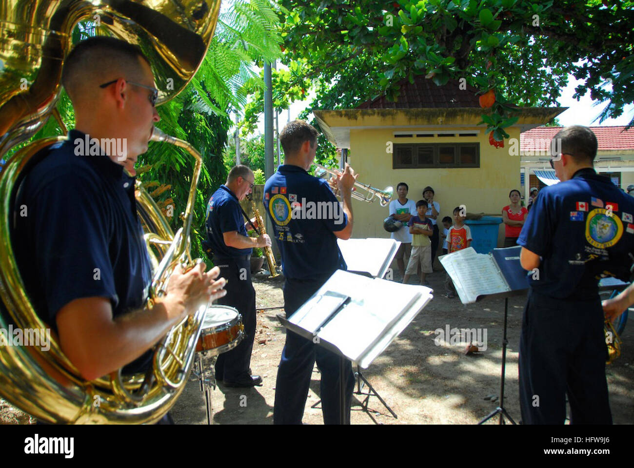 080626-N-9689V-011 NHA TRANG, Vietnam (June 26, 2008) Members of the Pacific Fleet Dixie Band, embarked aboard the Military Sealift Command hospital ship USNS Mercy (T-AH 19) perform for patients during a Pacific Partnership medical and dental civic action program held at the Dien Khanh Primary School in Nha Trang. This is the first time since 1975 that a U.S. military band has been permitted to perform in Vietnam. The mission involves partnerships with the armed forces of Vietnam, Vietnamese health care professionals, and local government officials. U.S. Navy photo by Mass Communication Speci Stock Photo