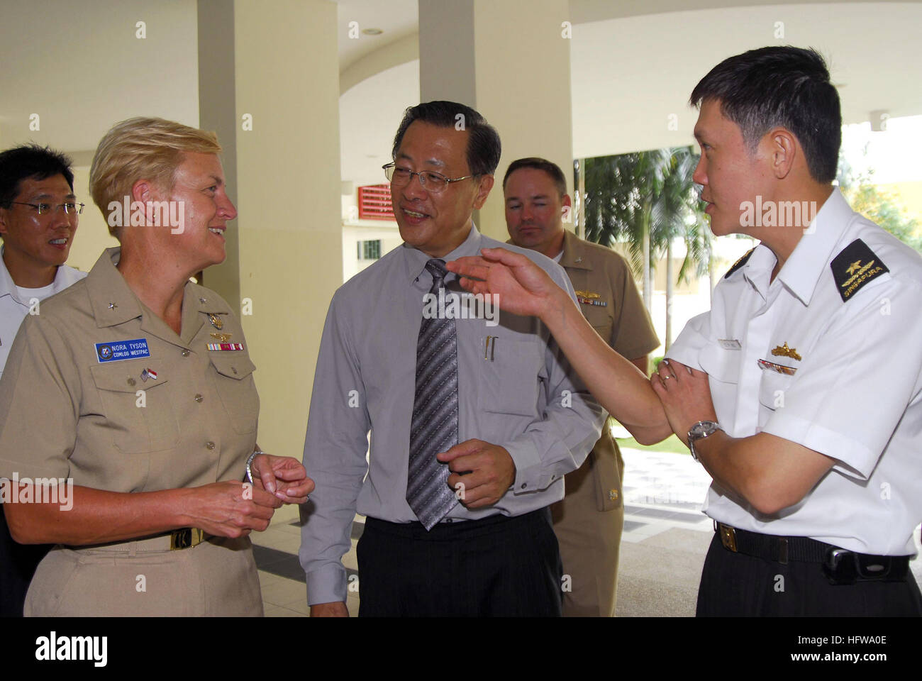 080701-N-7095C-013 SINGAPORE (July 1, 2008) Rear Adm. Nora W. Tyson, left, commander of Logistics Group Western Pacific, Lim Yeon Khee, Movement for the Intellectually Disabled of Singapore (MINDS) public relations official and public education committee chairman, and Rear Adm. Ng Chee Peng, fleet commander for the Singapore Armed Forces Navy, talk during a visit to MINDS for a community relations project. Service members from the U.S. and Singapore are participating in the project as a part of Cooperation Afloat Readiness and Training (CARAT) 2008. CARAT is an annual series of bilateral train Stock Photo