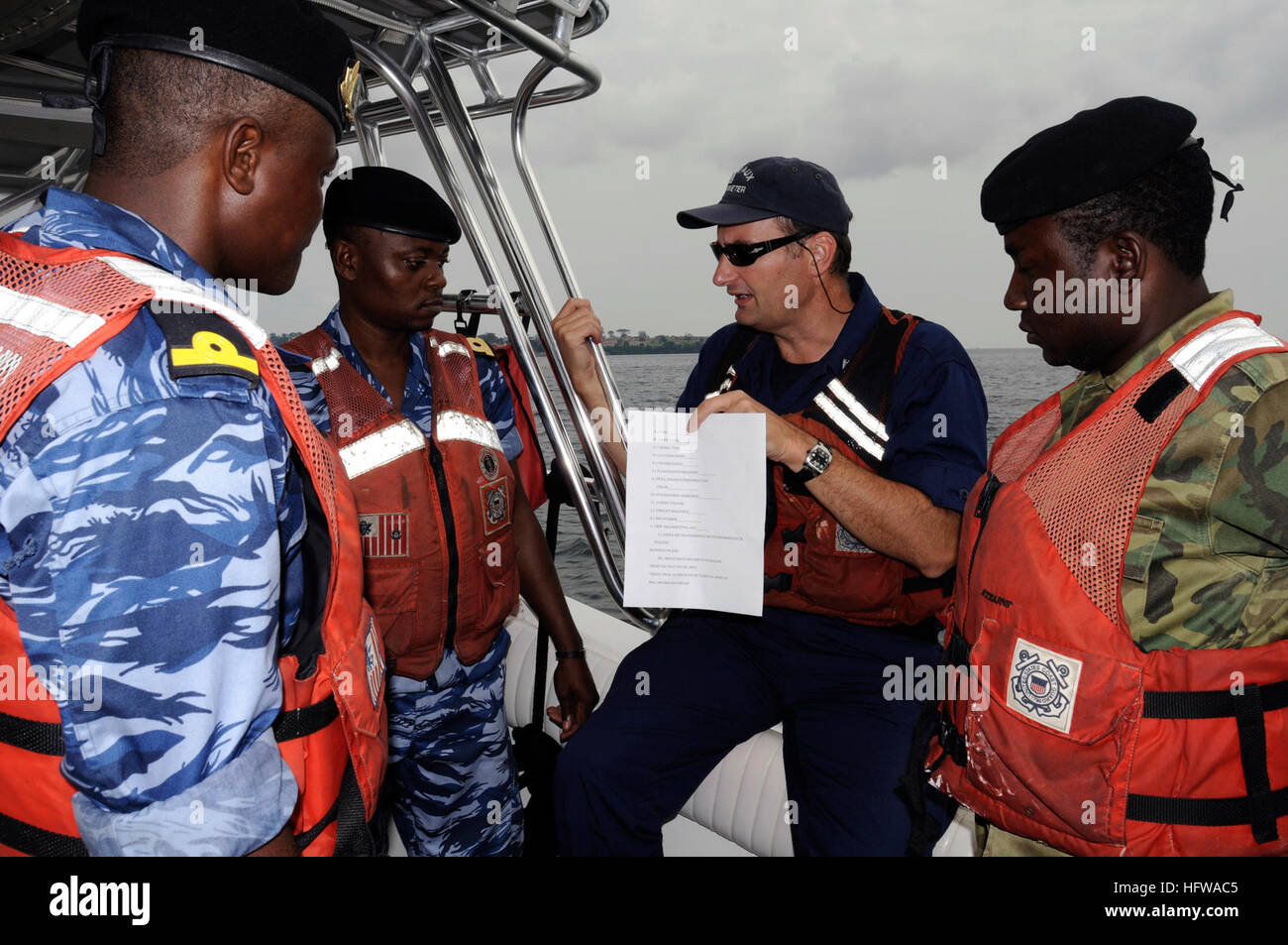 080710-G-2443T-001 MALABO, Equatorial Guinea (July 10, 2008) Lt. Richard Turrin, a member of the Coast Guard Auxiliary, translates boarding procedures aboard the U.S. Coast Guard Cutter Dallas (WHEC 716) for several Equatorial Guinea naval officers during a mock boarding. Turrin is deployed to the region as a translator supporting Africa Partnership Station (APS). APS is an initiative aimed at strengthening global maritime partnerships through training and other collaborative activities in order to improve global maritime safety and security. U.S. Coast Guard photo by Public Affairs Specialist Stock Photo