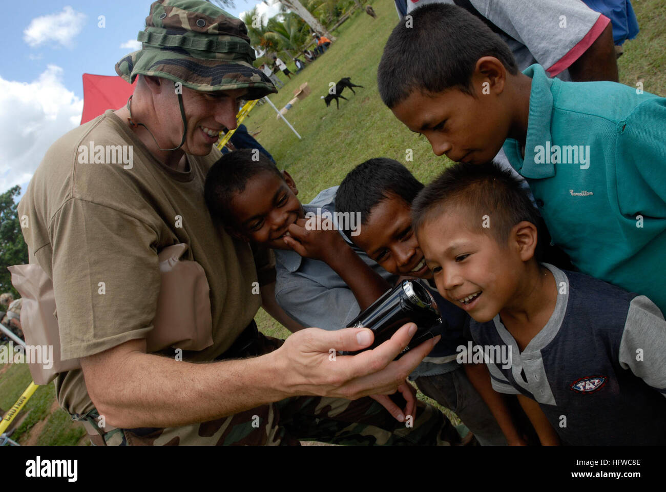 Lt. Cmdr. Nathan Uebelhoer, embarked aboard the amphibious assault ship USS Kearsarge, shows a group of Nicaraguan children the pictures he has taken of them playing soccer at a community relations event during Continuing Promise 2008. CP is an equal-partnership mission between the United States, Canada, the Netherlands, Brazil, Nicaragua, Panama, Colombia, Dominican Republic, Trinidad and Tobago and Guyana. USS Kearsarge in Continuing Promise 2008 DVIDS110391 Stock Photo