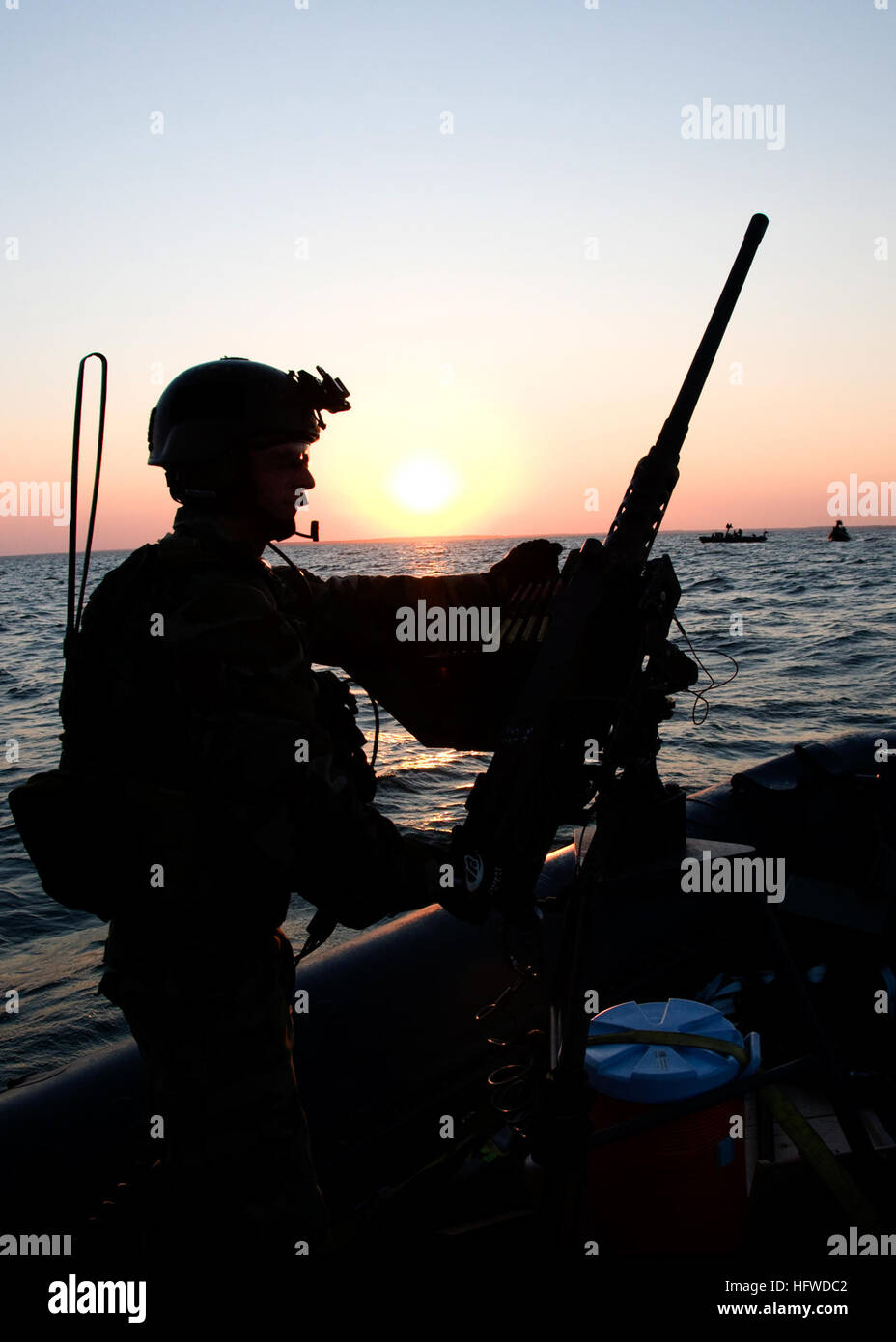 080903-N-4500G-416 PINEY ISLAND, N.C. (Sept. 3, 2008) A Special Warfare Combatant-craft Crewman (SWCC) from Special Boat Team 20 holds a .50-caliber machine gun steady in between live-fire drills on the Pamlico Sound. Several Naval Special Warfare 11-meter rigid-hull inflatable boat detachments participated in the training, which included training on grenade launchers and .50-caliber machine guns preparing for an upcoming deployment supporting the Global War on Terror. (U.S. Navy photo by Mass Communication Specialist 3rd Class Robyn Gerstenslager/Released) US Navy 080903-N-4500G-416 A Special Stock Photo