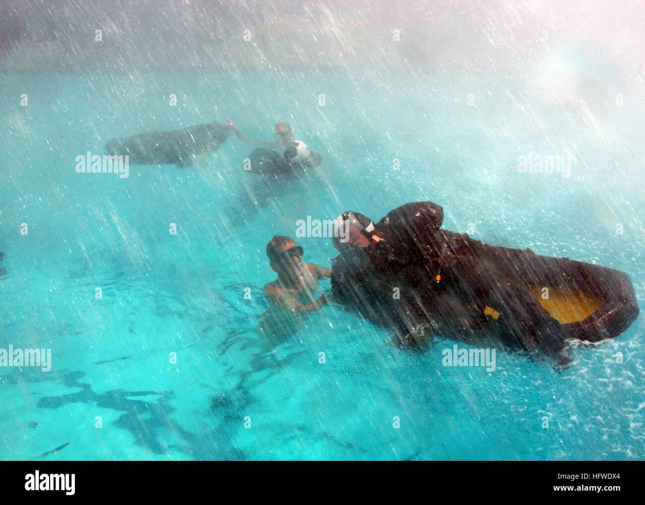 An instructor demonstrates proper life raft exit procedures to a ...