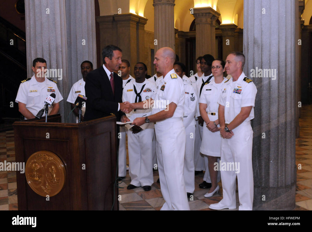 080925-N-2539L-010  COLUMBIA, S.C. (Sept. 25, 2008) Rear Adm. John Goodwin, commander, Naval Air Forces Atlantic, accepts from South Carolina Governor Mark Sanford, a certificate proclaiming this week Columbia Navy Week. Sailors from Navy Recruiting District Raleigh and Navy Operational Support Center Columbia participated in a media event in the State House Rotunda with Goodwin and Sanford. Navy Weeks are designed to raise awareness in metropolitan areas that do not have a significant Navy presence. (U.S. Navy photo by Chief Mass Communication Specialist Hugh C. Laughlin/Released) US Navy 080 Stock Photo