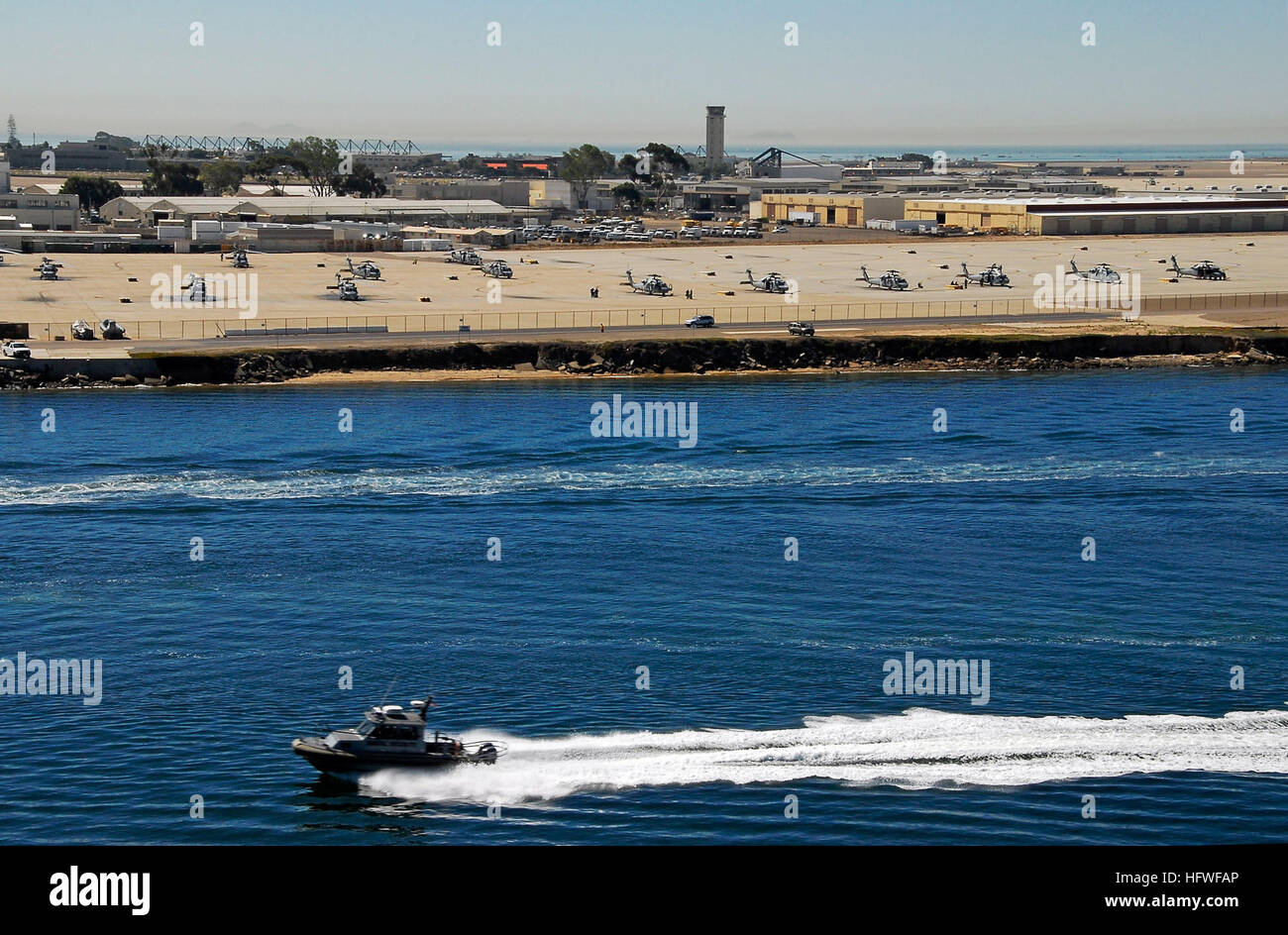 A naval security boat patrols the waters off the coast of Naval Air Station North Island. Security boats that patrol areas surrounding naval bases assist mission readiness and enhanced maritime traffic stability. USS Boxer cruises through San Diego DVIDS122213 Stock Photo