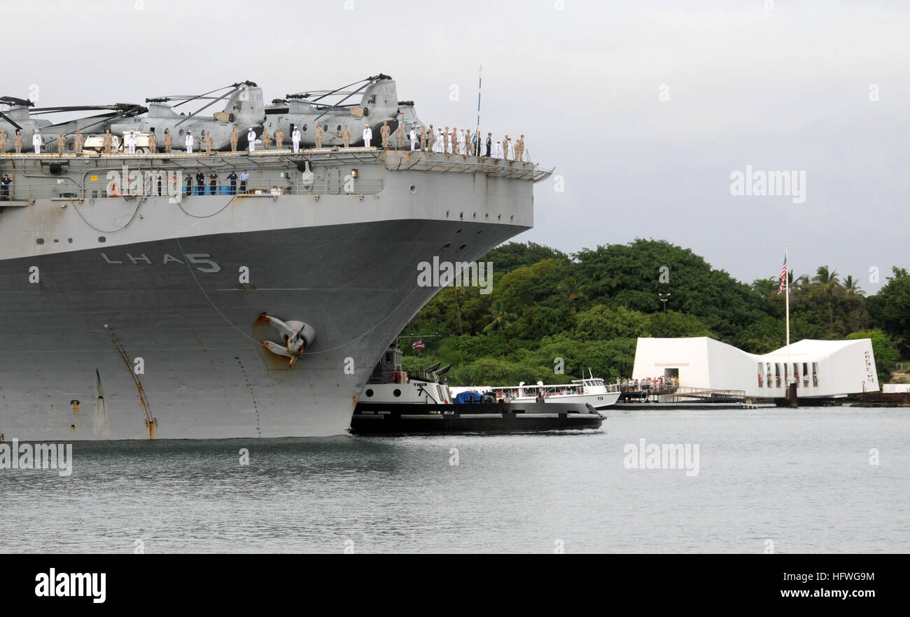 Sailors and Marines aboard USS Peleliu (LHA 5) man the rails while ...