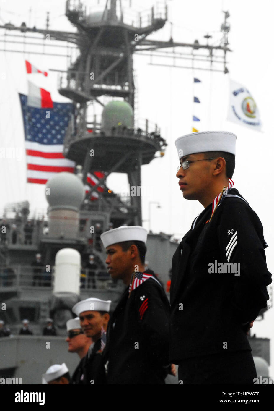 Sailors aboard the amphibious assault ship USS Peleliu (LHA 5) man the ...