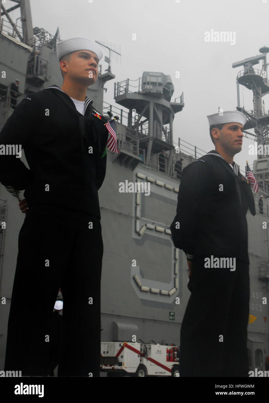 Sailors aboard amphibious assault ship USS Peleliu (LHA 5) man the ...