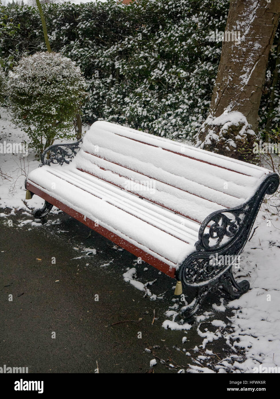 A Wooden park bench covered in snow Stock Photo - Alamy