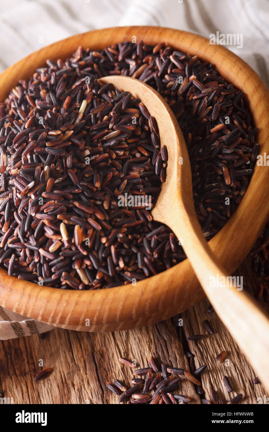 Black Rice Wild Rice Raw wild black rice macro in a wooden bowl. vertical background Stock ...