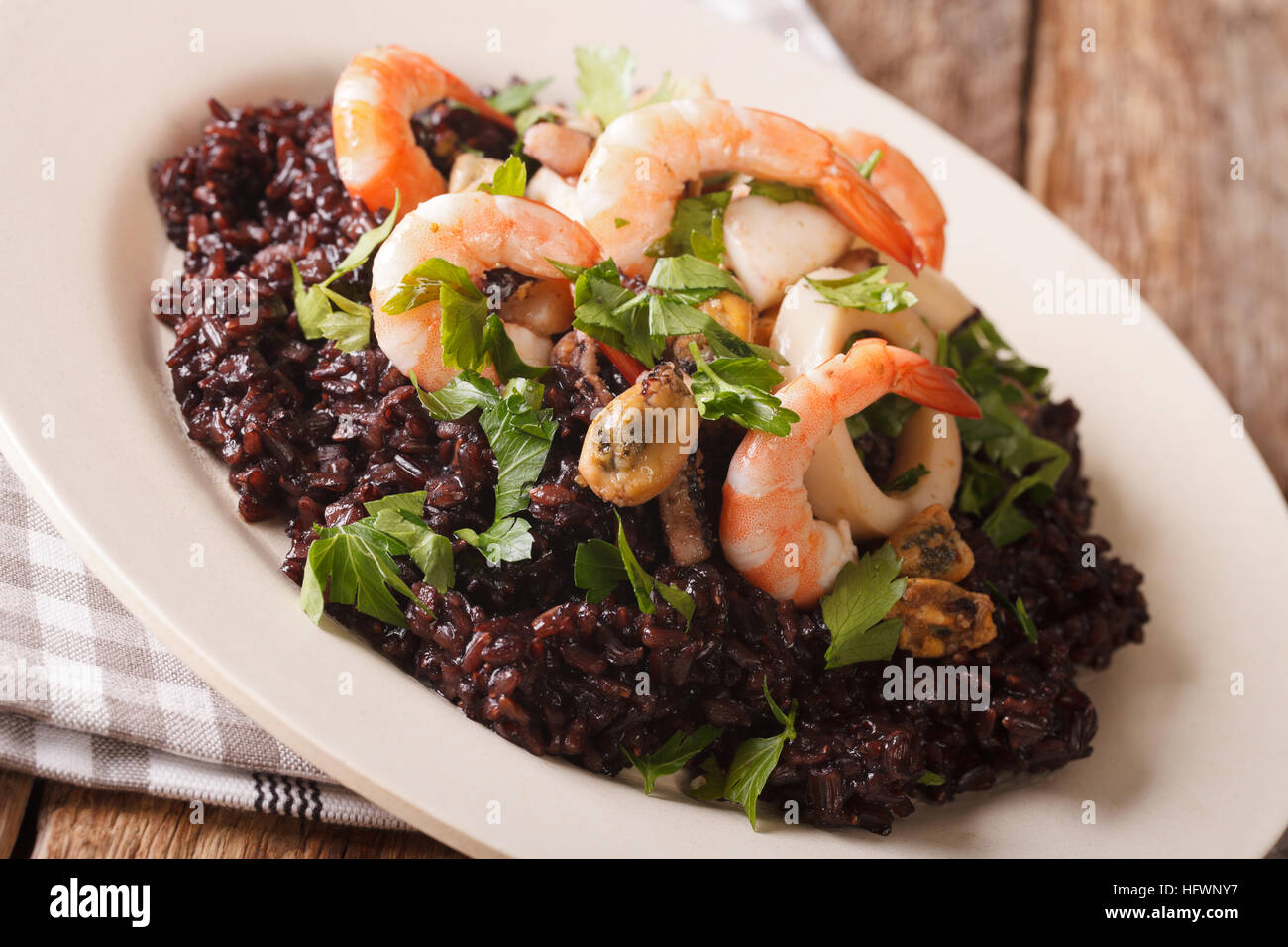 Wild black rice with shrimp, calamari, mussels and scallops close up on