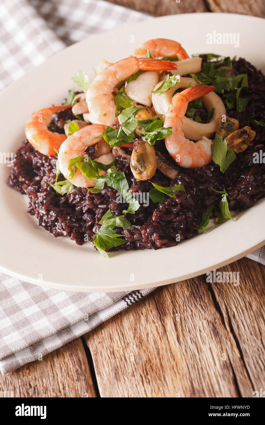 Wild black rice with shrimp, calamari, mussels and scallops close up on