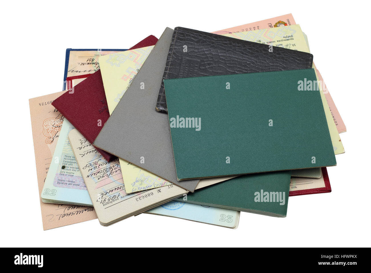 Pile of ancient personal illegal documents.These are no name passports, diplomas, the driving license and other. Covers from imitation leather. Isolat Stock Photo