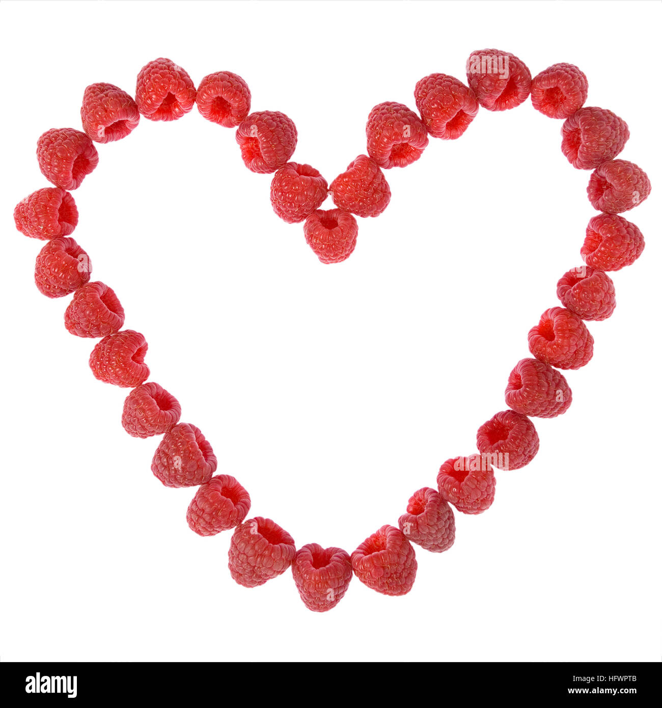 Heart made out of raspberries on white background Stock Photo - Alamy