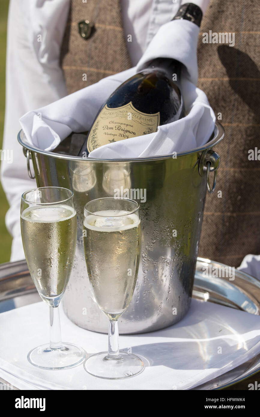 Champagne bottle and flutes served by waiter Stock Photo Alamy