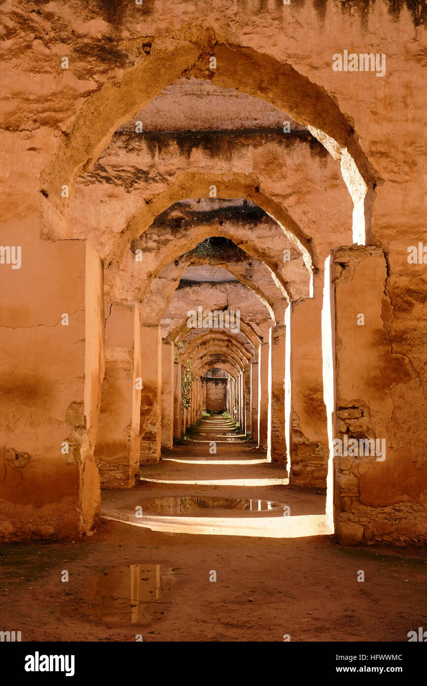 Many ancient, Islamic stone archways framed within each other of the Royal Stables in the Imperial Palace in Meknez, Morocco. Stock Photo
