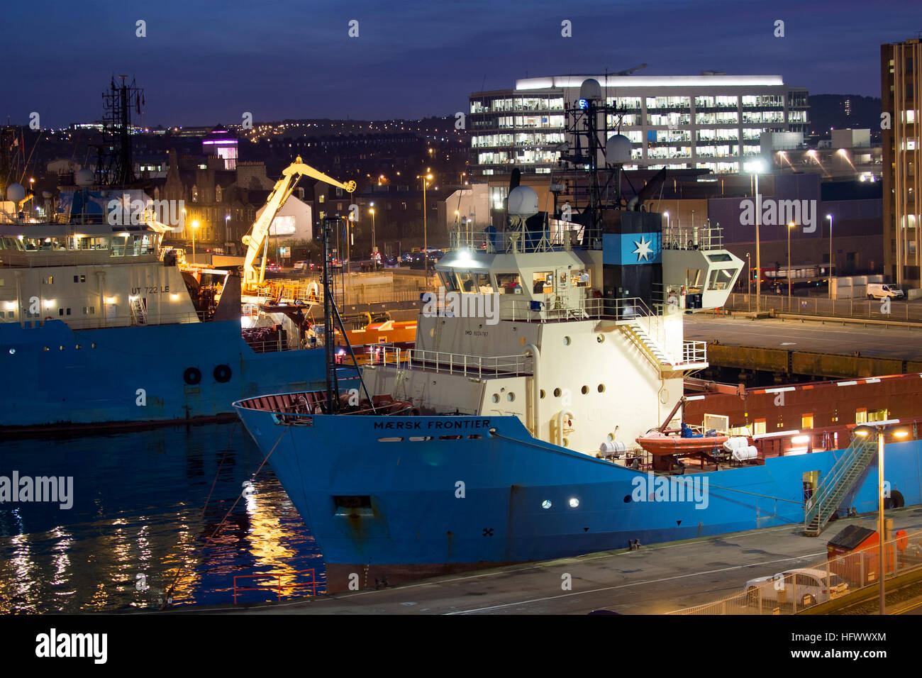 Night view of oil industry support ships and buildings at Aberdeen harbour, Scotland Stock Photo