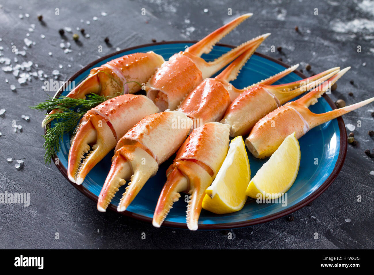 Cooked crab claws with lemon, sea salt and pepper on a concrete background Stock Photo Alamy