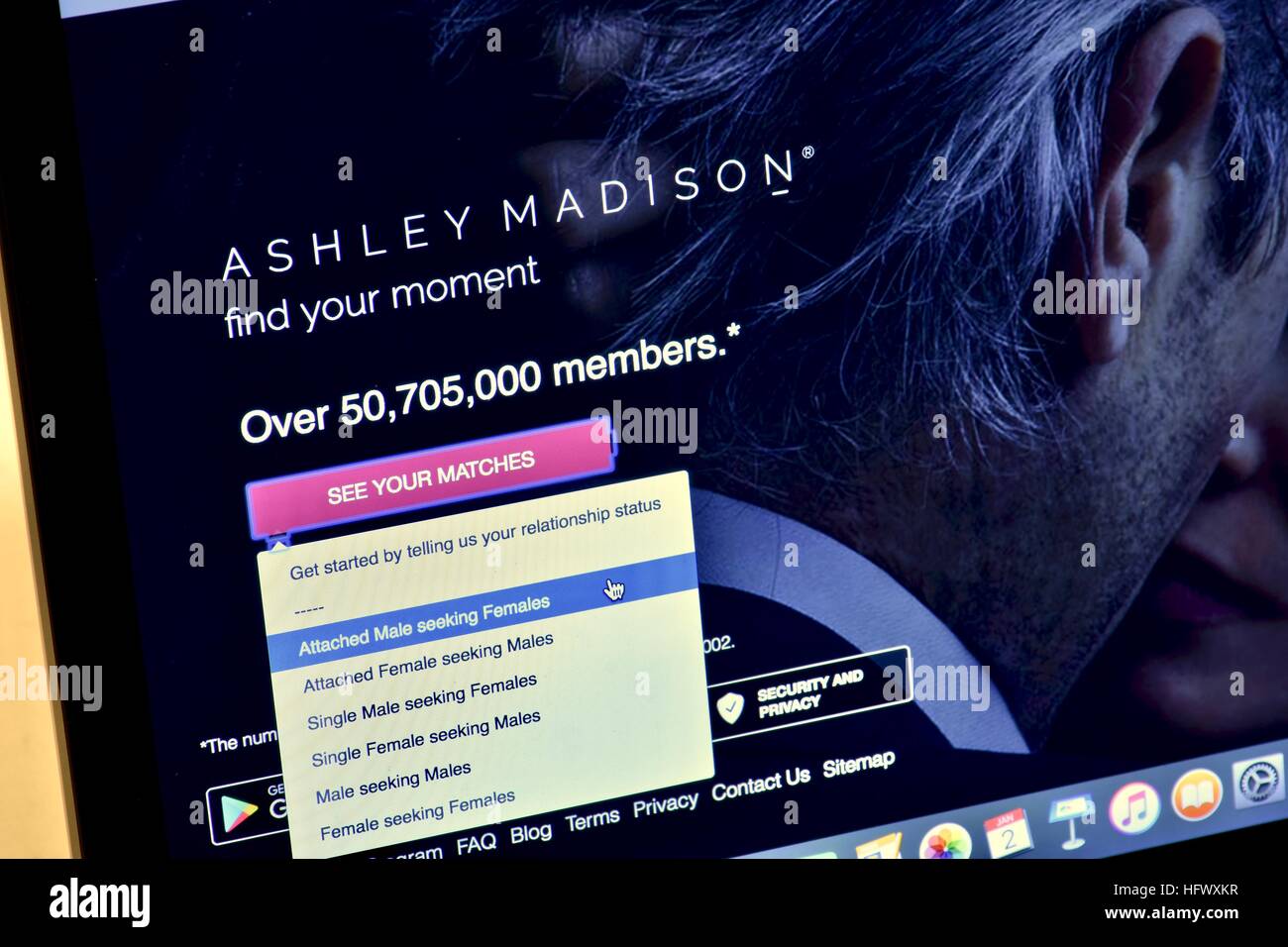 An Apple Macbook Pro displayed on a white marble surface with a married man viewing the Ashley Madison hookup website Stock Photo